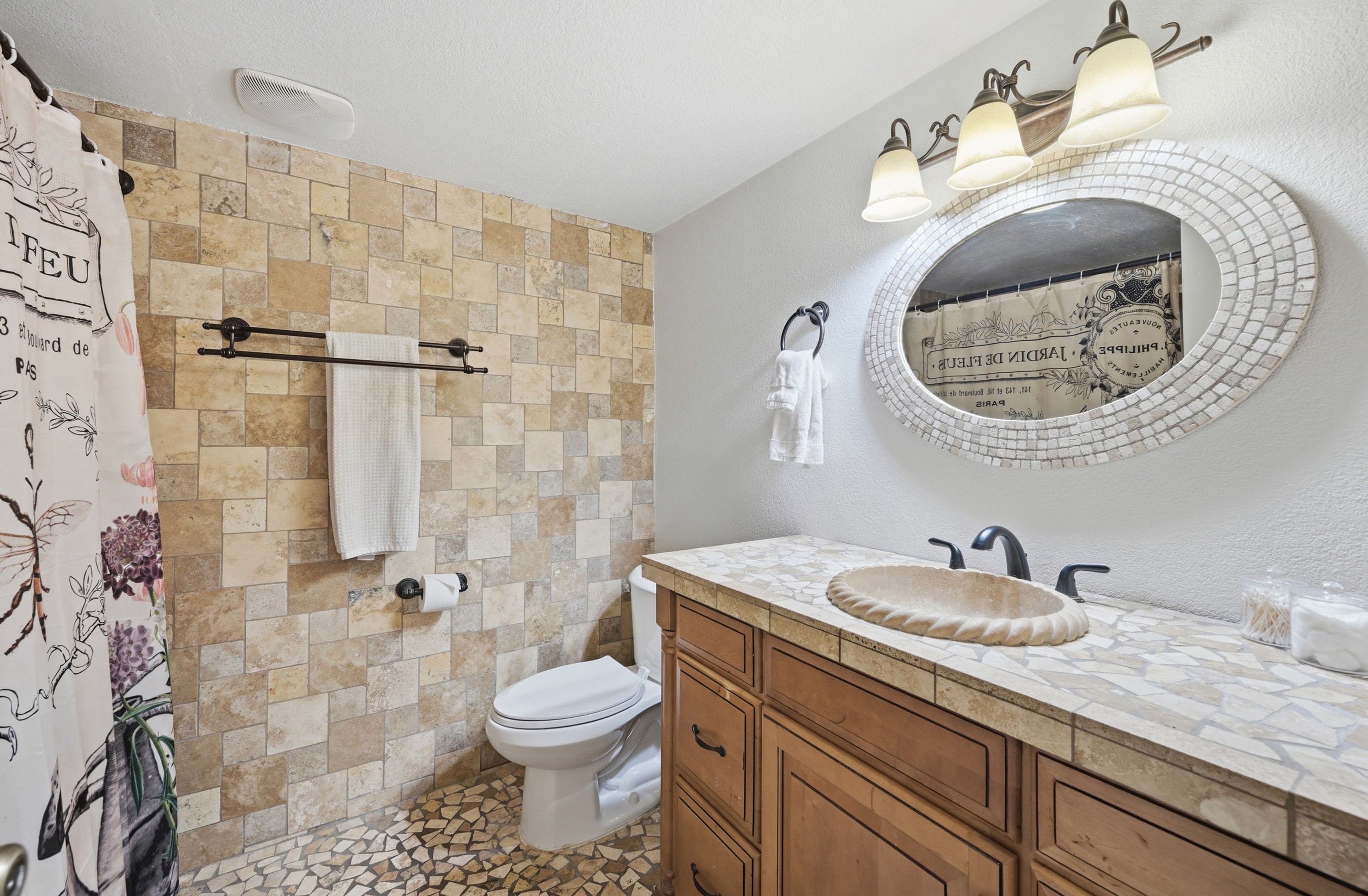 Soft lighting and earthy tilework create a warm, welcoming vibe for your morning routine or evening wind-down.
