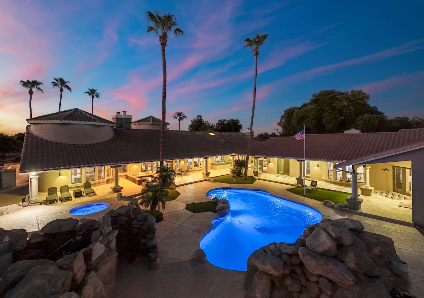 Experience ultimate relaxation with this luminous pool framed by swaying palms and luxurious patio spaces.

