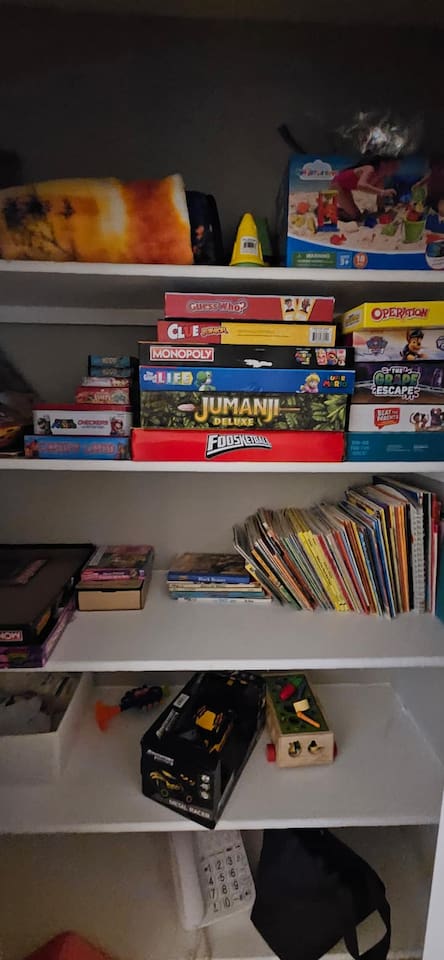 Closet treasure trove of books and board games, perfect for gamenights, cozy reading sessions, and keeping little ones entertained.