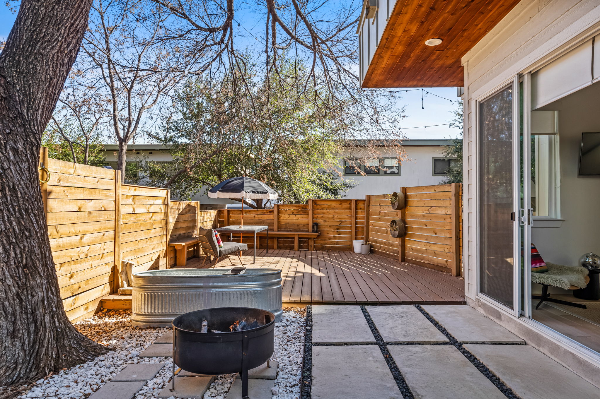 Inviting courtyard featuring a fire pit and easy access to indoor living spaces