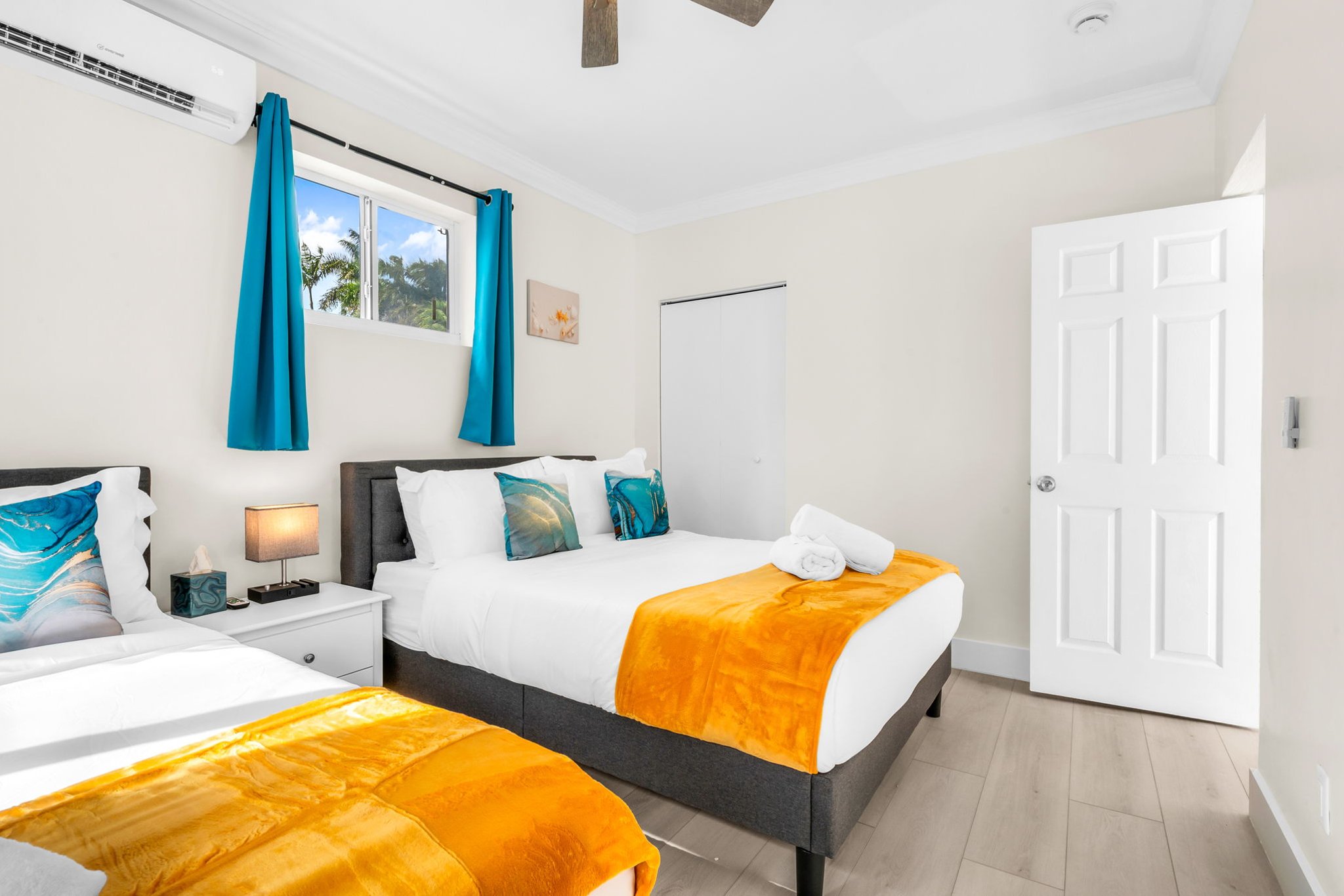Relax in the sunny 4th bedroom—complete with two full-size beds, coastal décor, and a freshly updated ensuite bathroom.