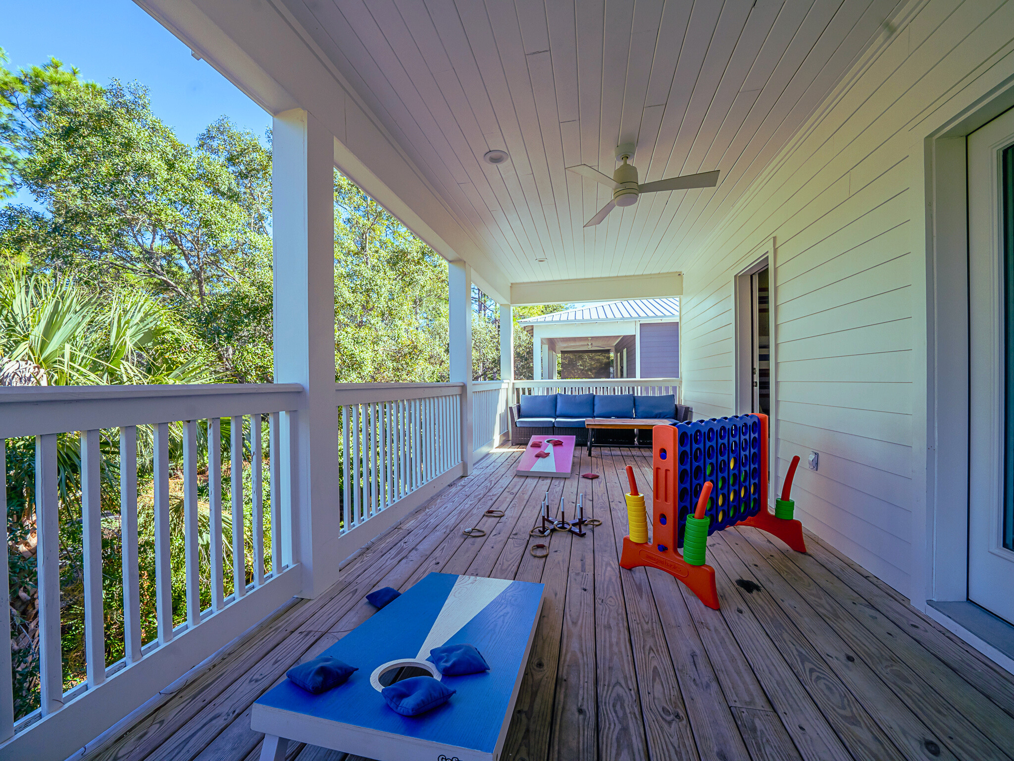 Spacious deck with seating areas, cornhole, and ring toss - perfect for outdoor fun and relaxing evenings