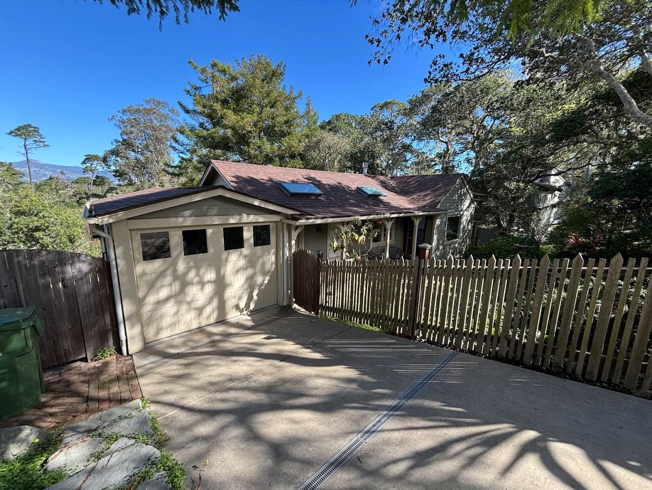 Down slope driveway, single car garage not accessed from interior of the house.