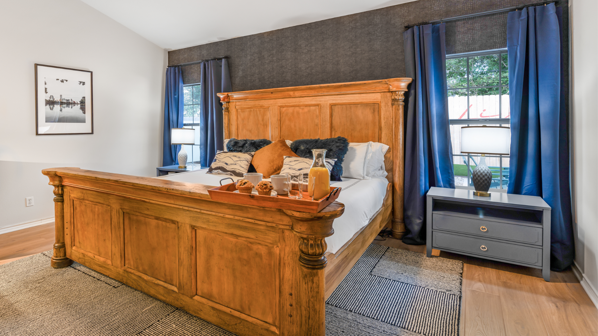 Unwind in this elegant bedroom, featuring a Spanish style bed perfect for a cozy retreat. Enjoy a late morning with nature streaming through the windows. Your ultimate getaway for relaxation!