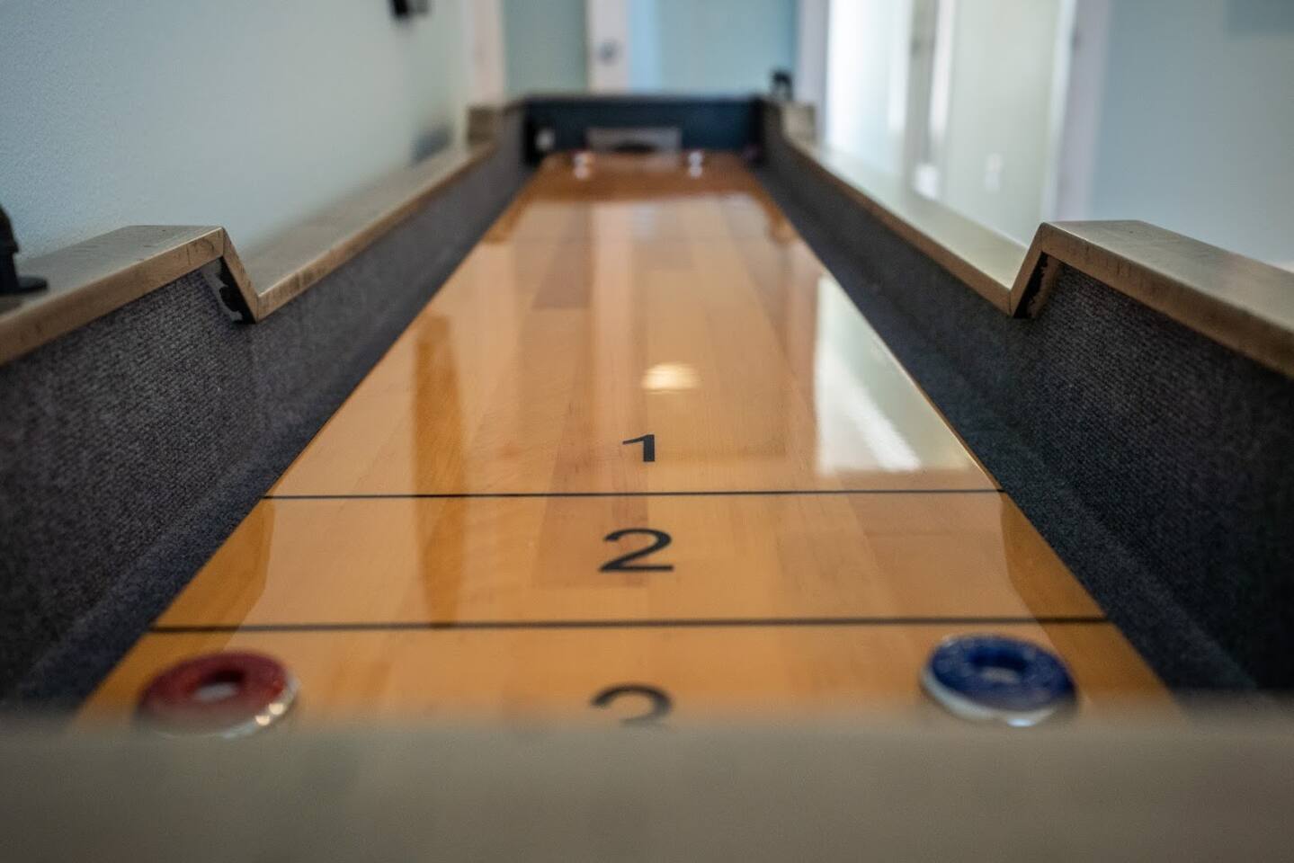 First floor sitting room/game room shuffle board with electronic dart board above.