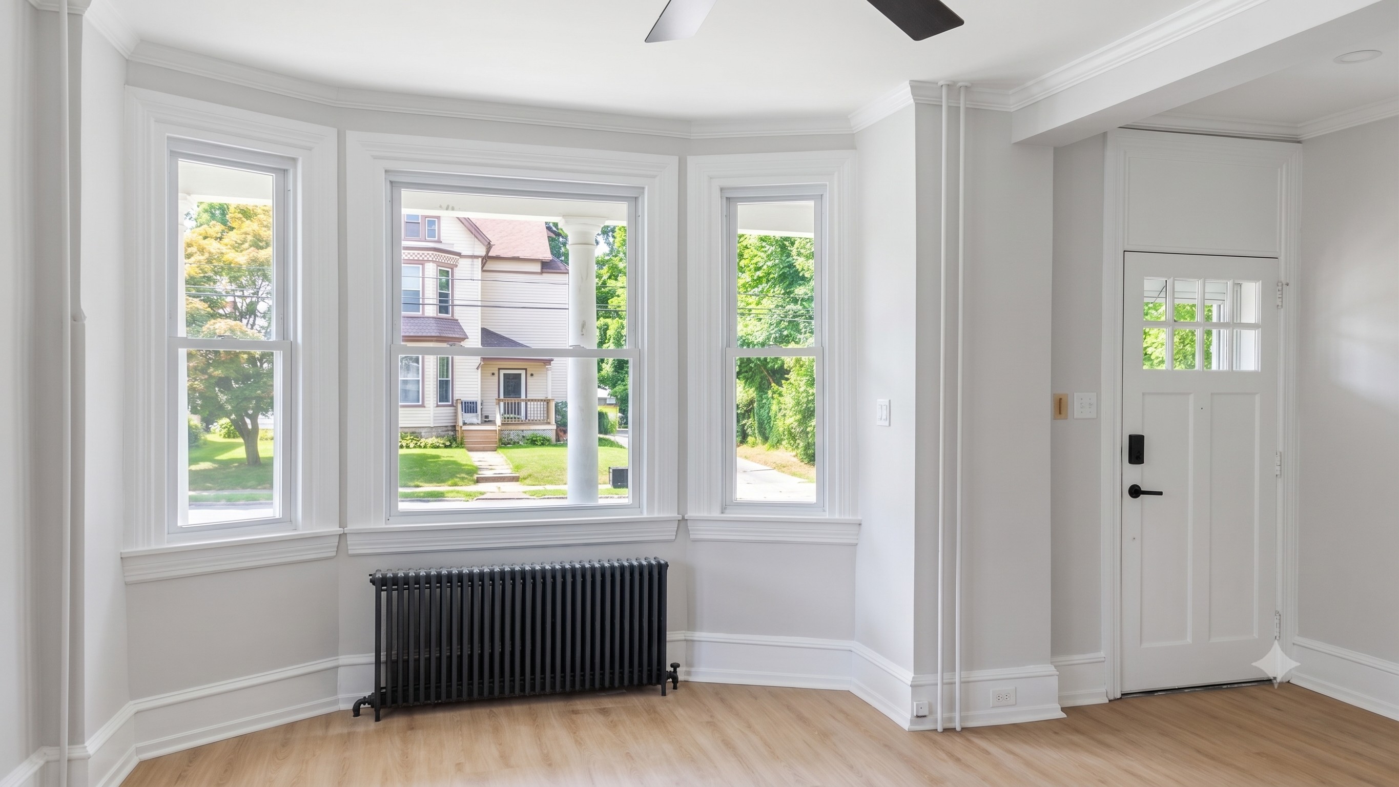Bay windows and ceiling fans offer plenty of light and circulation throughout the entire space.