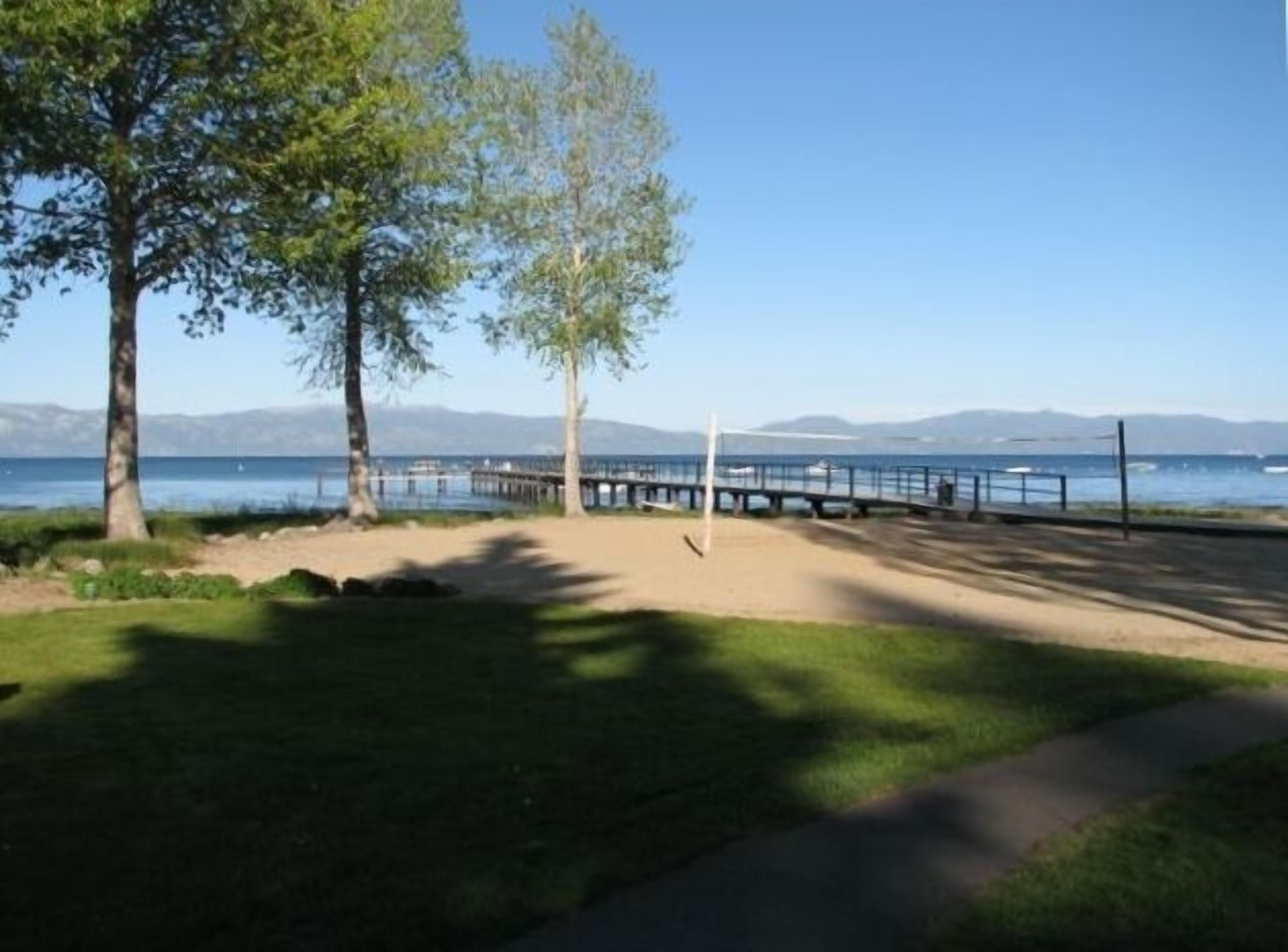 View of sand volleyball court, dock and Lake Tahoe from the living room