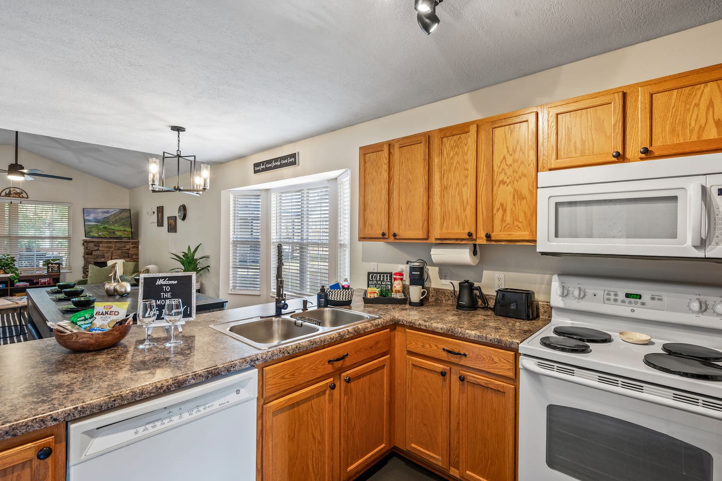Fully equipped kitchen with warm wood cabinets, modern appliances, and a cozy coffee station—perfect for cooking and relaxing during your stay.