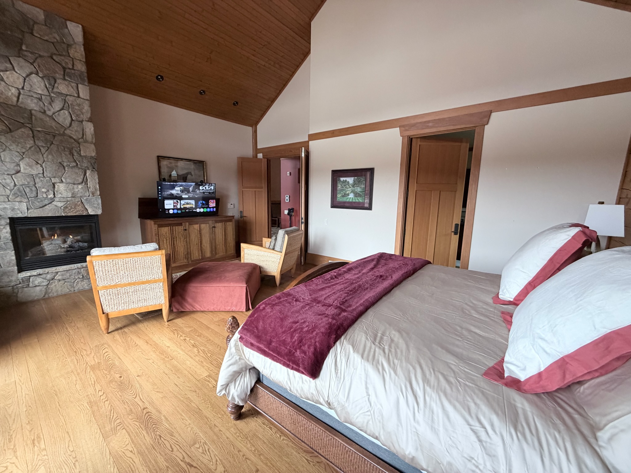 Spacious master bedroom featuring a comfortable king bed and a cozy propane fireplace