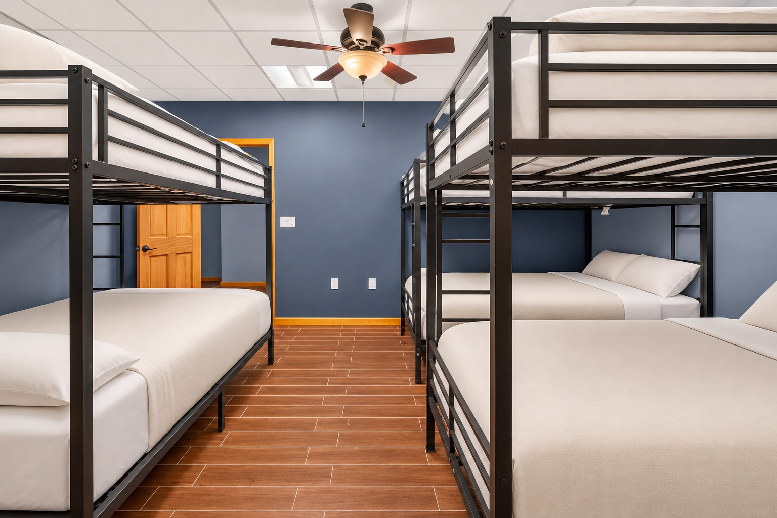 Spacious bunk room with white bedding