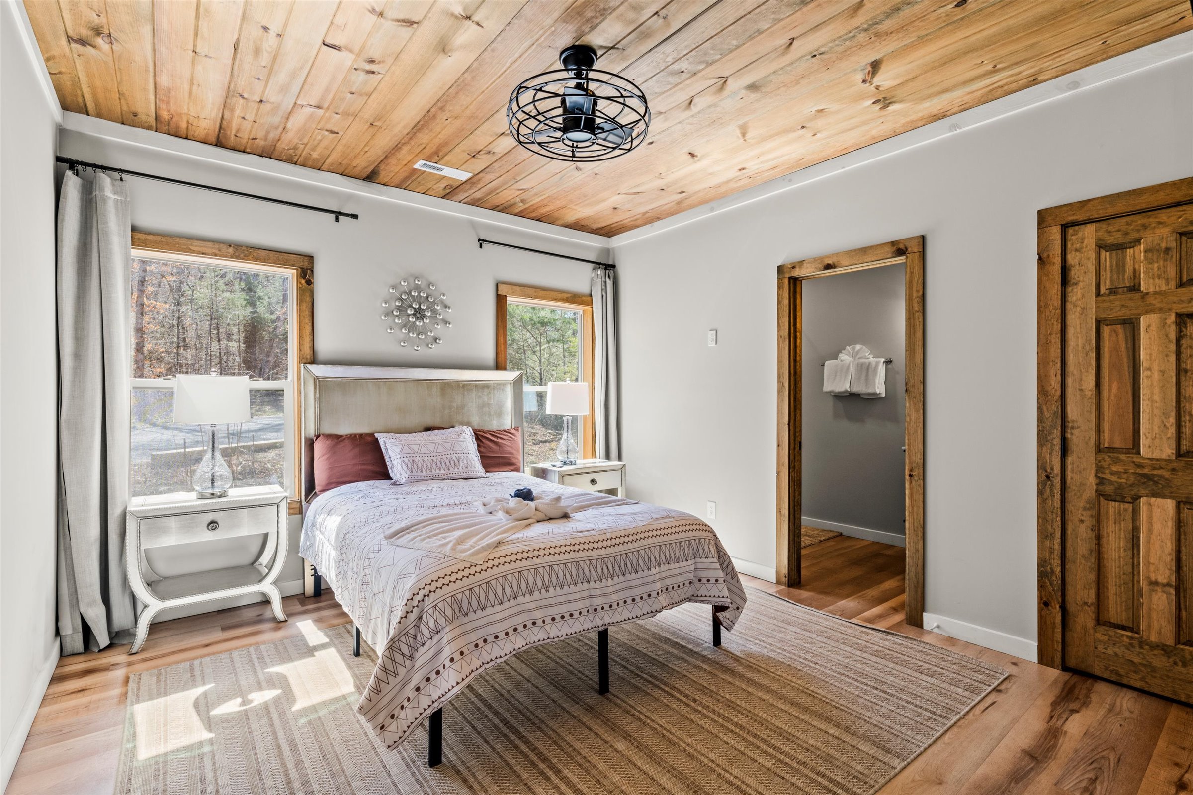 A warm and welcoming space featuring a comfortable queen bed and soft, ambient lighting.