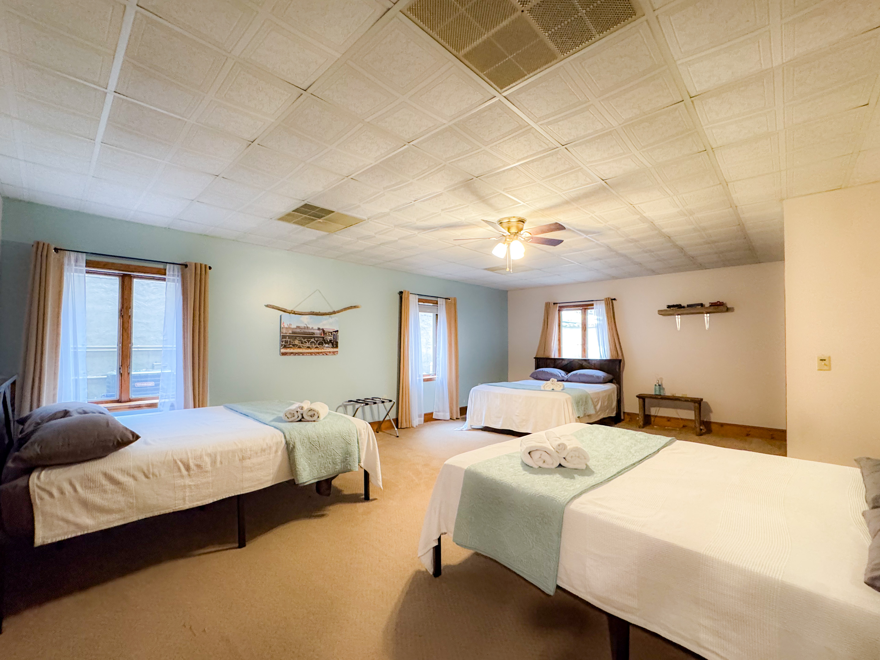 the Smoky Mountain Railroads themed bedroom features three queen bed sand is setup for the teenagers/older kids in the family