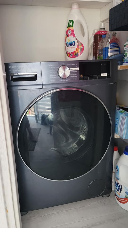 Full size washing machine in the common area shared with downstairs apartment