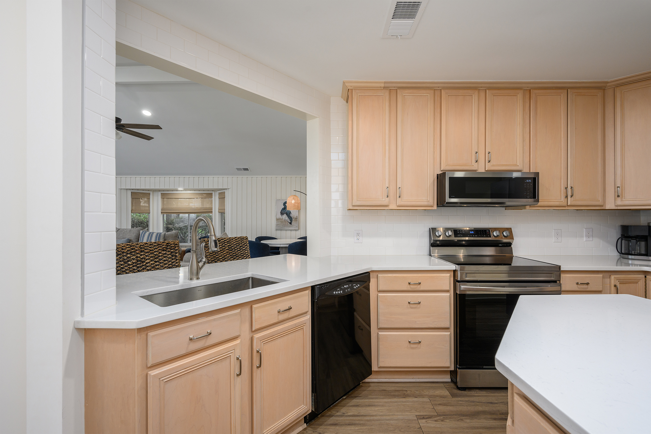 Kitchen opens to living room and features a breakfast bar
