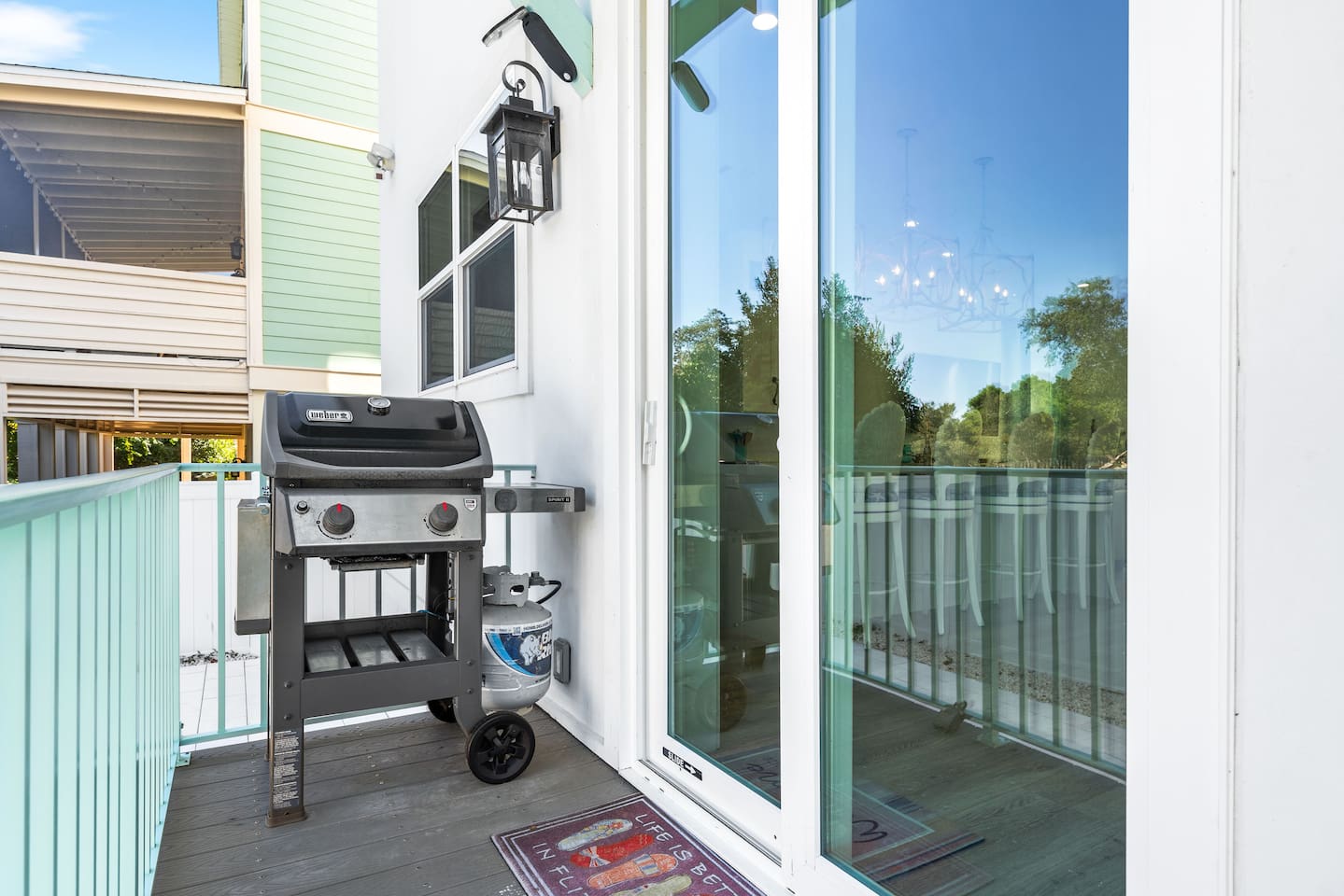 Fenced backyard oasis! Slide open the glass doors to a Weber BBQ grill, perfect for alfresco dining. Choose to eat at the outdoor table, on the breezy upper deck, or stay cool inside. The ultimate private setup for your next summer cookout.