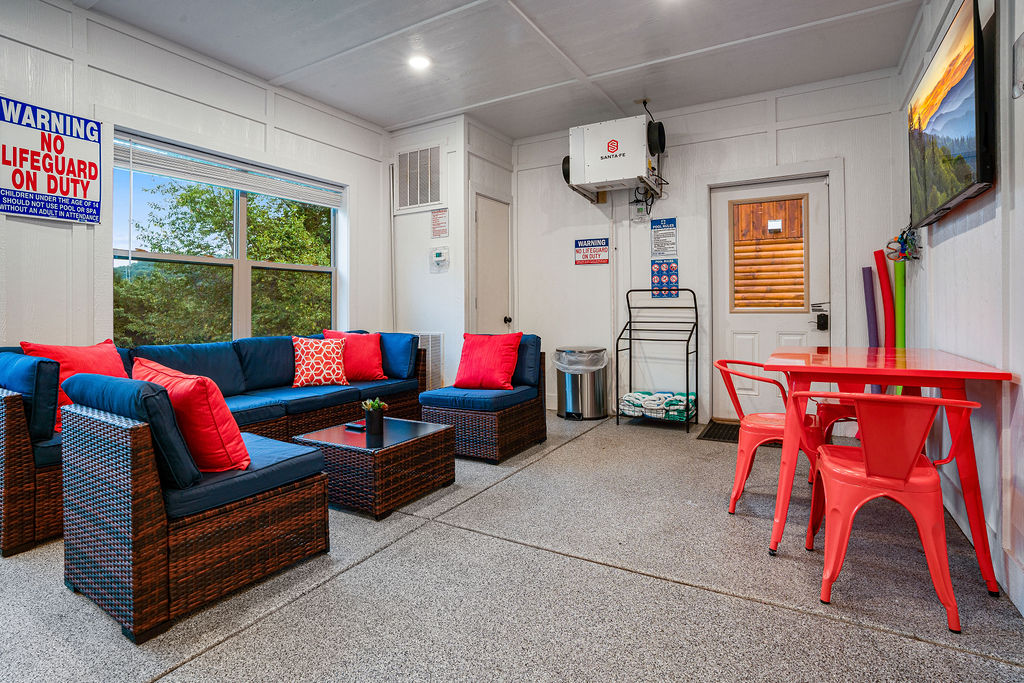 Relax poolside with comfortable seating just steps from the pool and hot tub located just outside the pool.  Also space to eat for 3 at the table and a 55" Smart TV to catch the big game or the latest Netflix series you can't miss.  