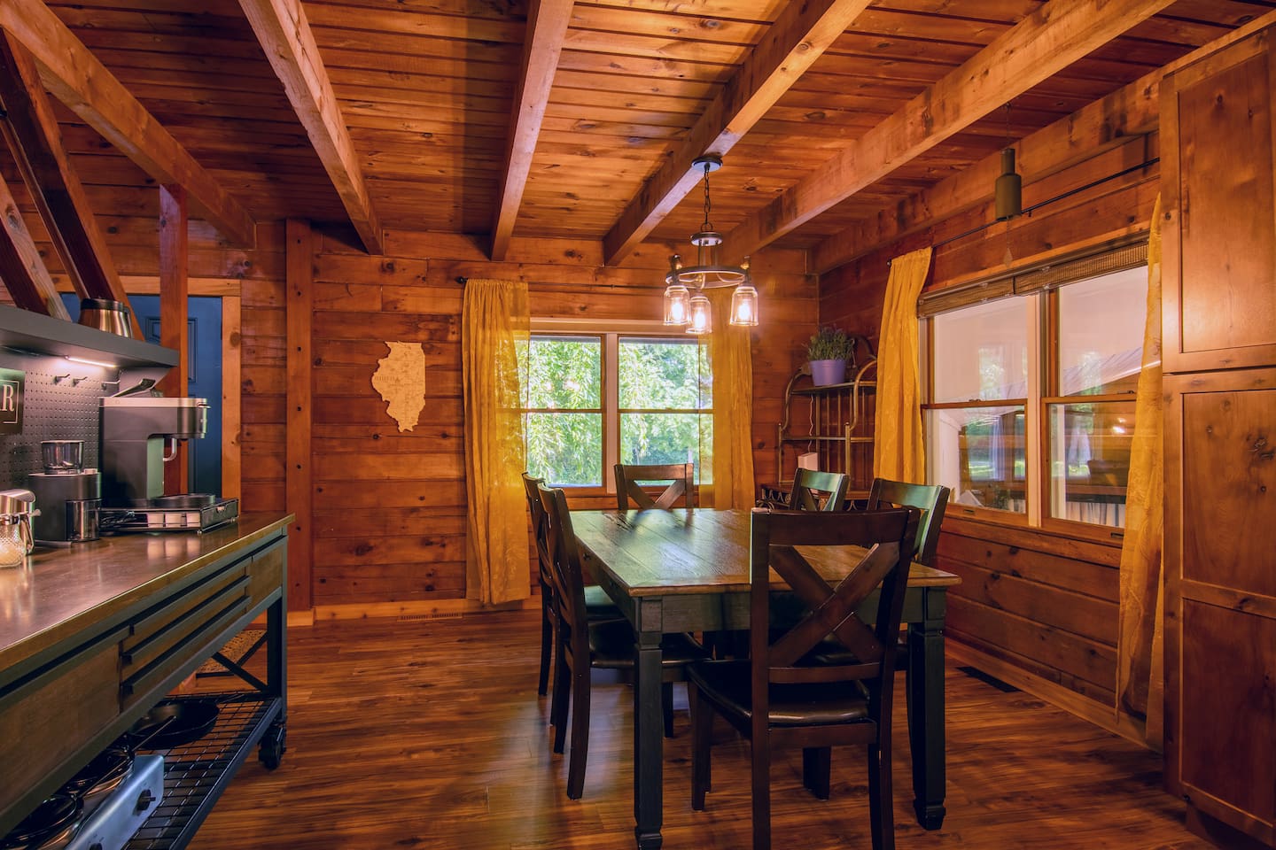 The dining area provides seating for 6 people at the table. There are 2 additional seats at the kitchen island. The pantry cabinet on the right provides storage space for your personal items.