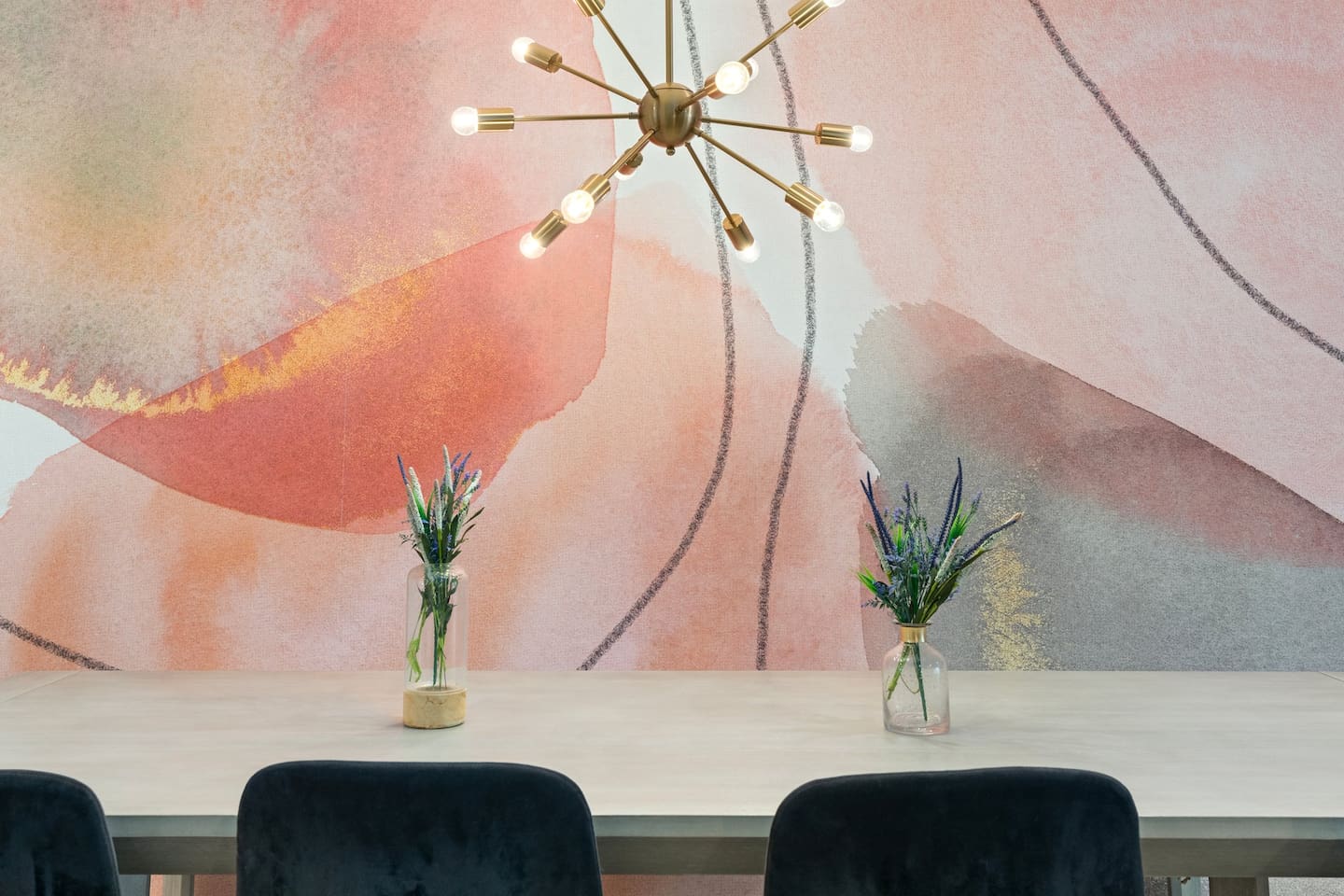 Fresh florals and soft lighting complement the natural hues of the table and walls, making every meal feel special.

