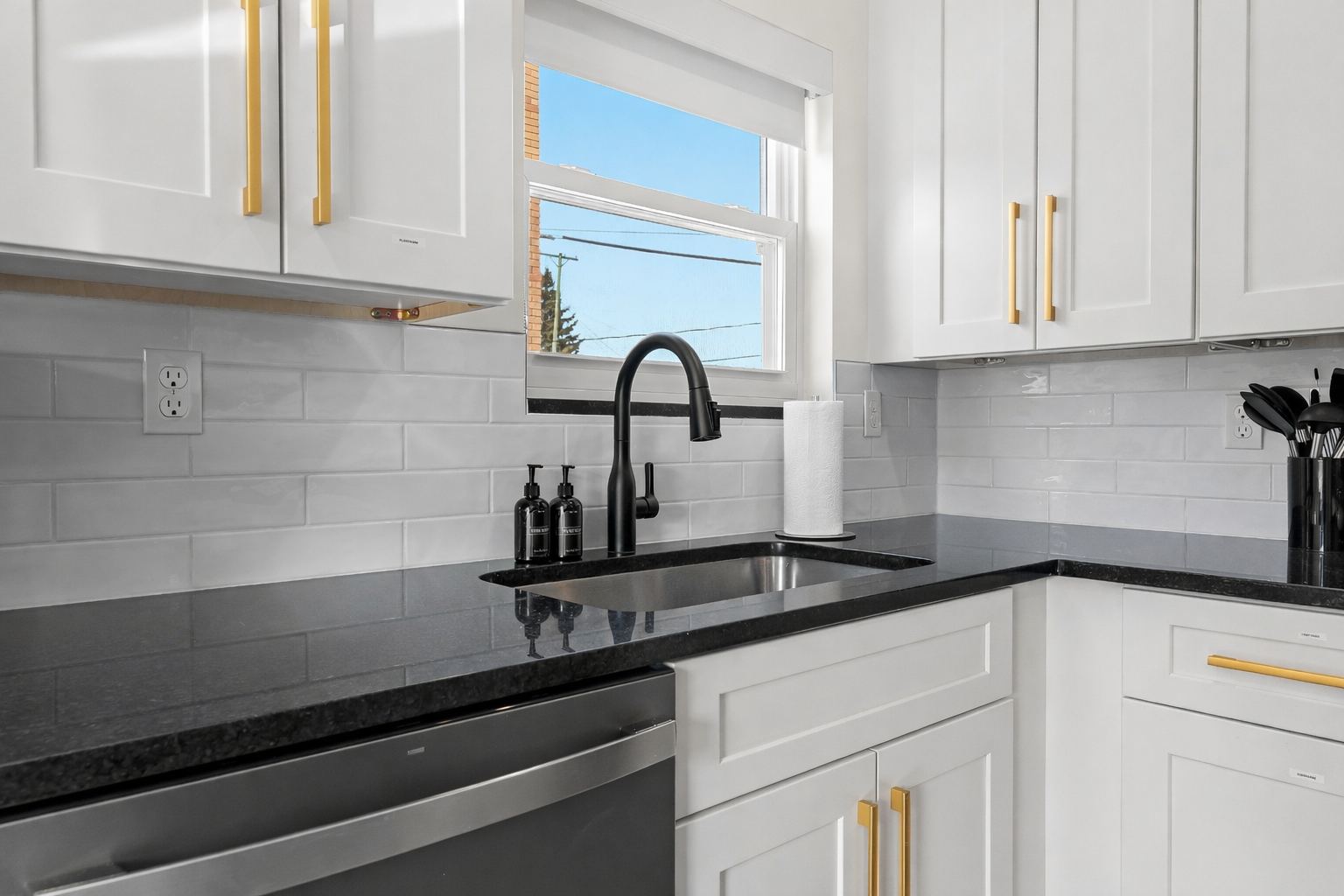 Clean, modern kitchen sink area with sleek fixtures, ample counter space, and natural light—making everyday prep and cleanup feel effortless.