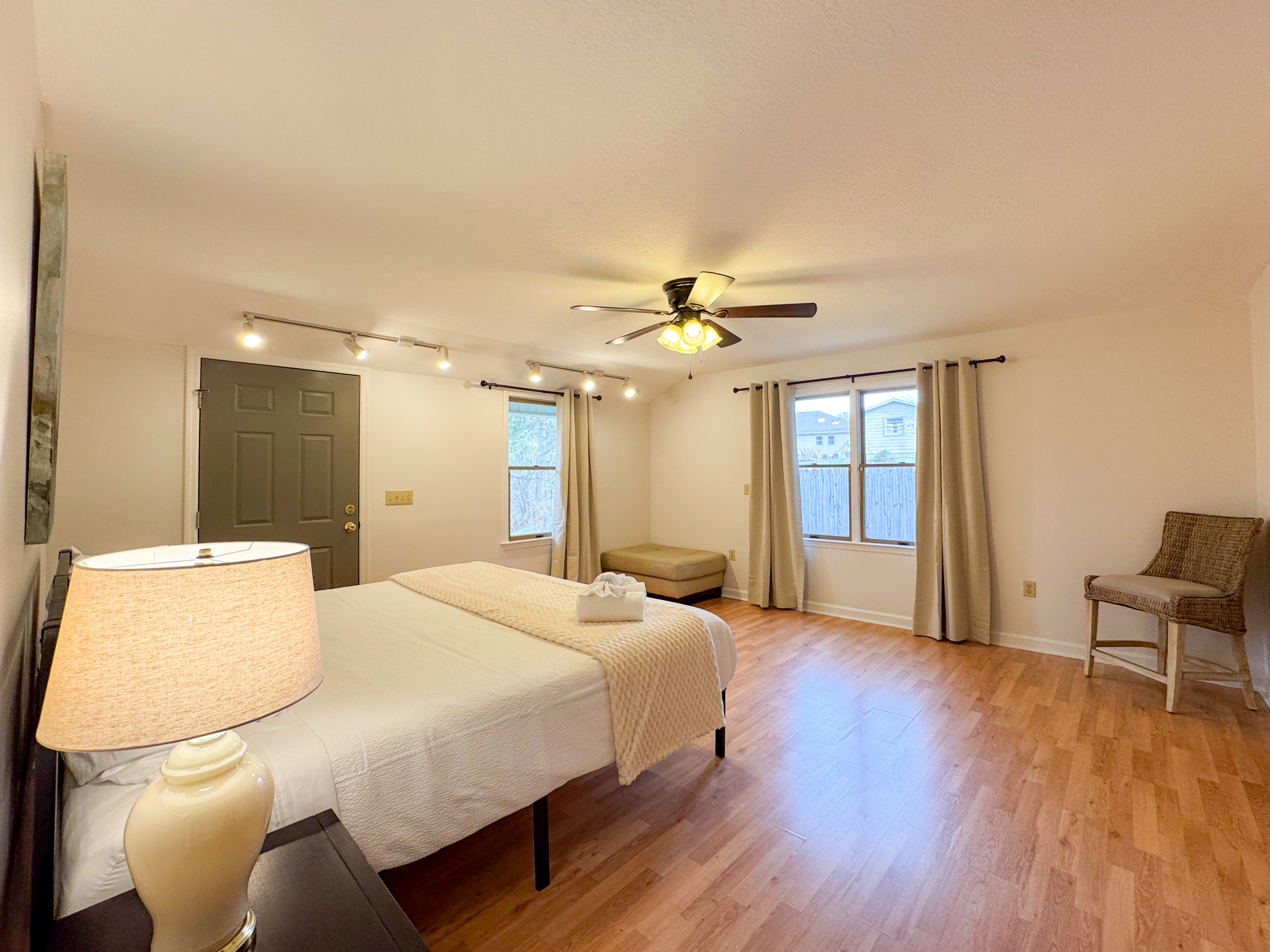 The master bedroom features a king size bed, large space, closet, and ensuite bathroom with accessibility features.