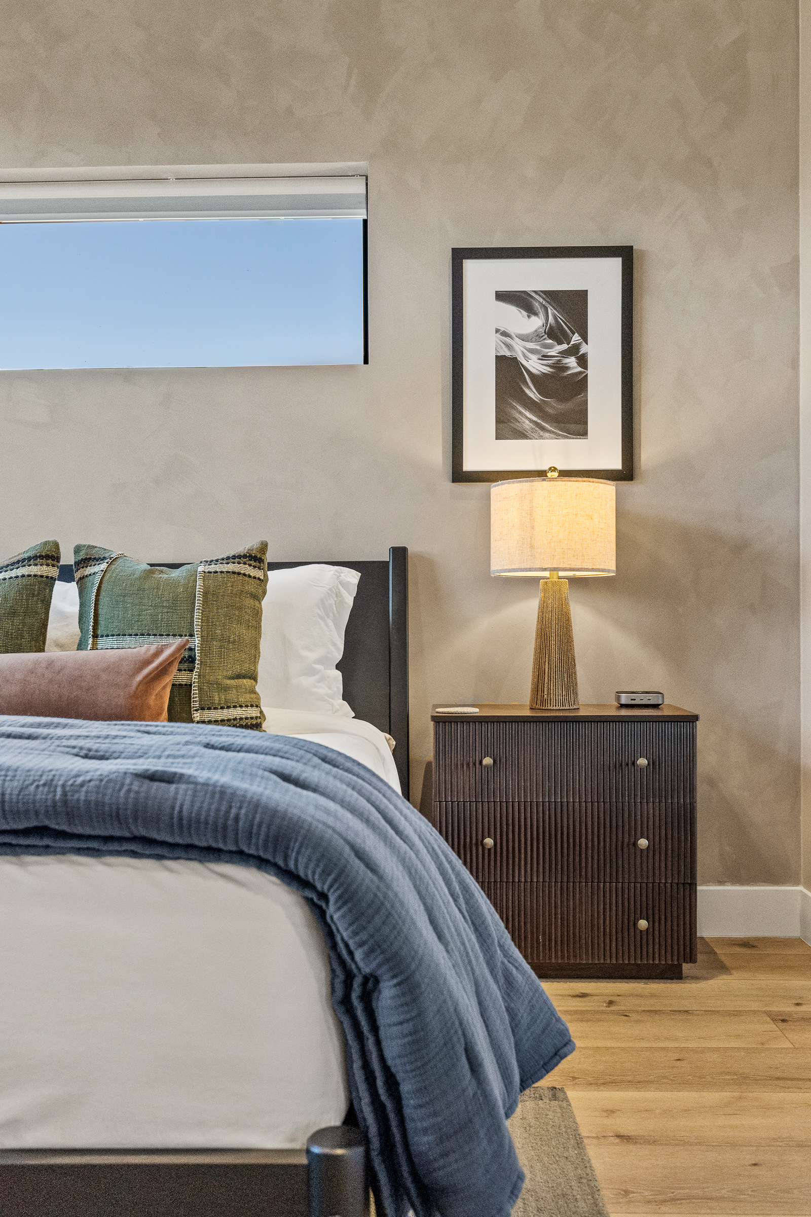 Soft bedding, warm lighting, and thoughtful details create a comfortable space for restful sleep. 