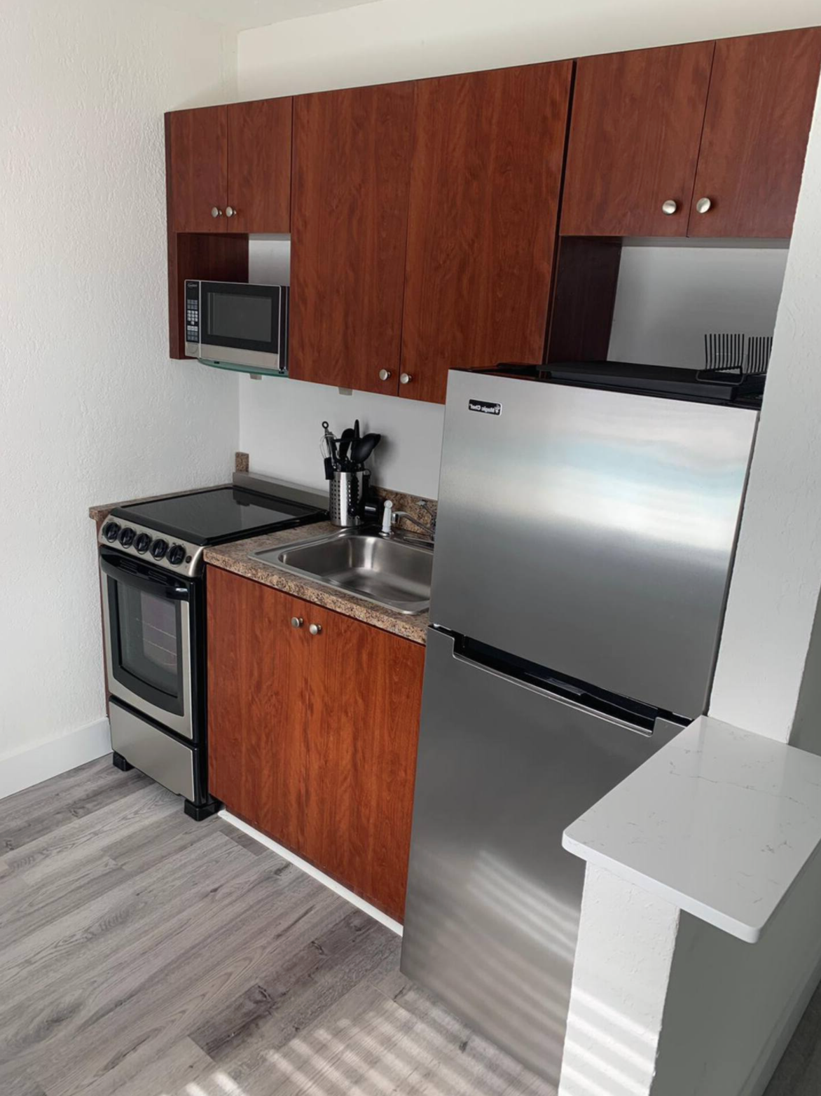 Fully stocked kitchen, stainless steel. 2m video tour link includes open cabinets to show supplies.