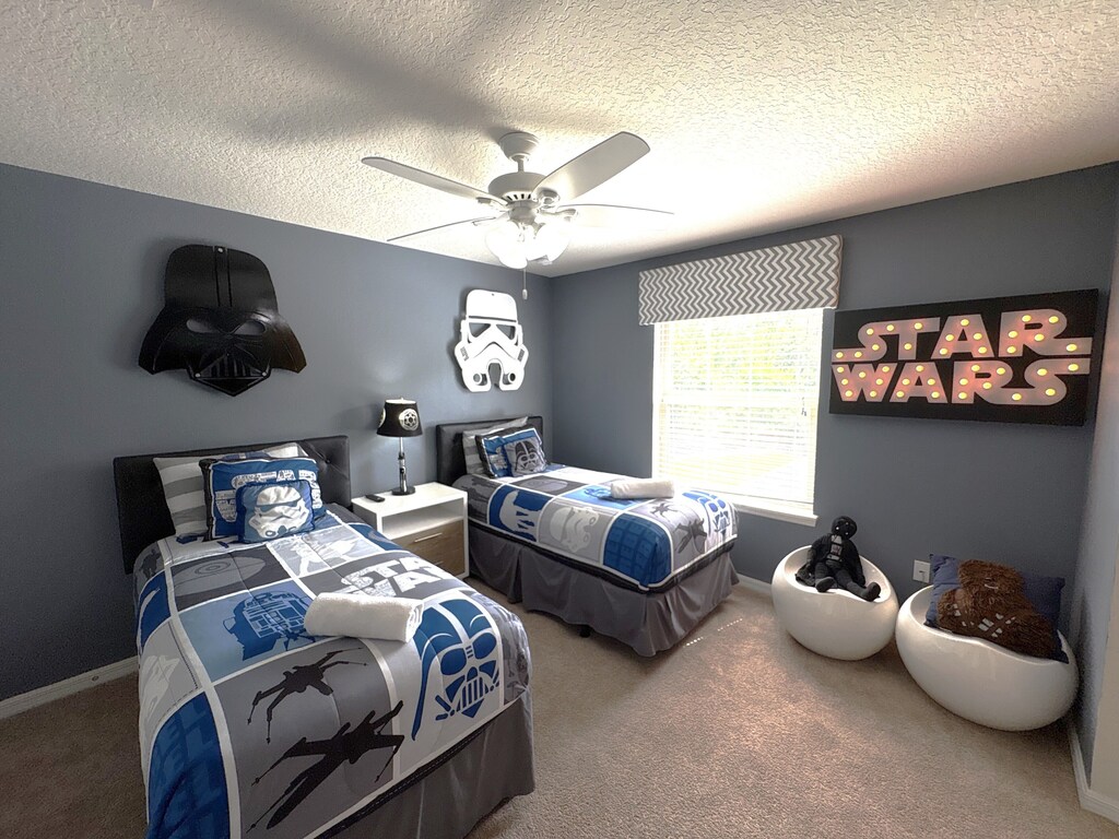 Star Wars themed room with decorative lights and characters and adjoining bath