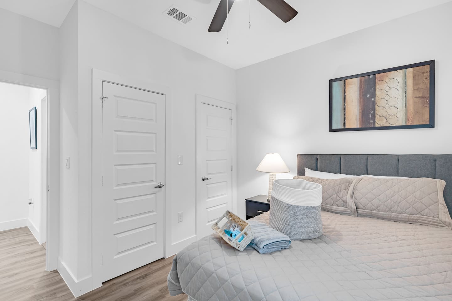 Another modern guest bedroom with a bright window and neutral palette