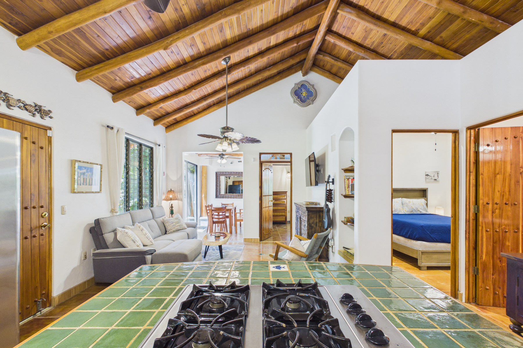 View from Kitchen to open living room and indoor dining.  Entry into Bedroom 1 and bedroom 2 off of living room. 