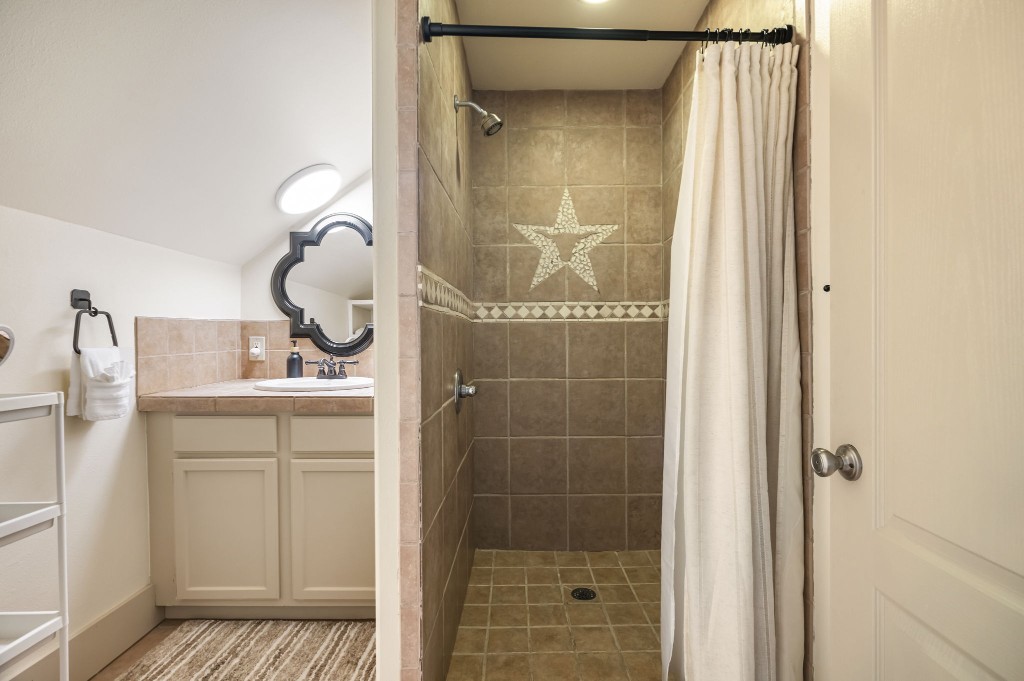 A full bathroom offers a single sink, shower, and toilet, providing everything needed for a self-contained stay.