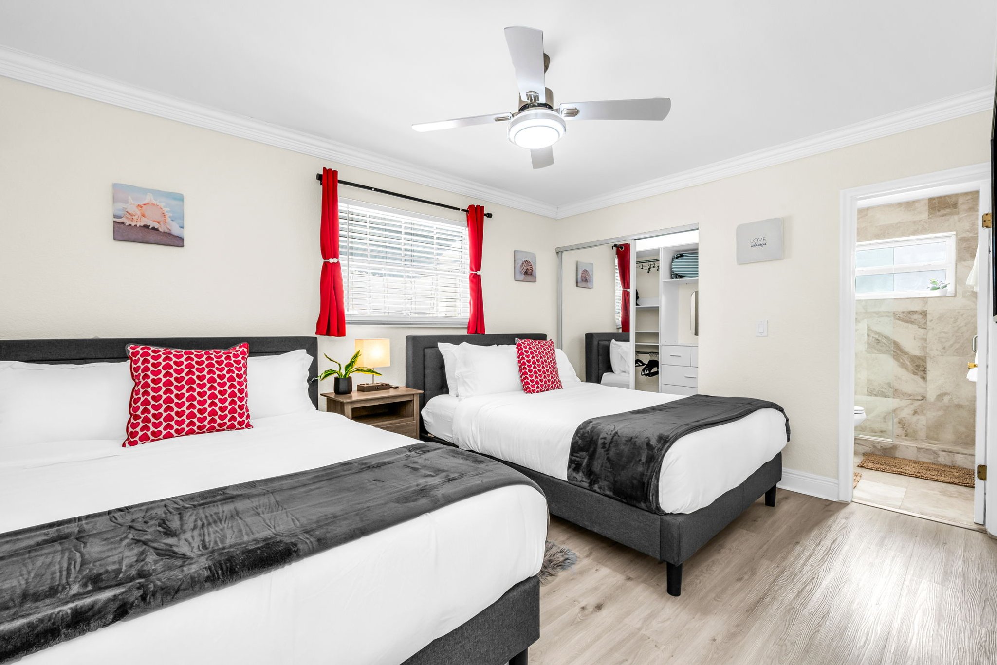 This inviting ensuite bedroom offers two plush queen beds, a smart TV for cozy nights in, and plenty of closet space plus a built-in vanity mirror for getting ready.