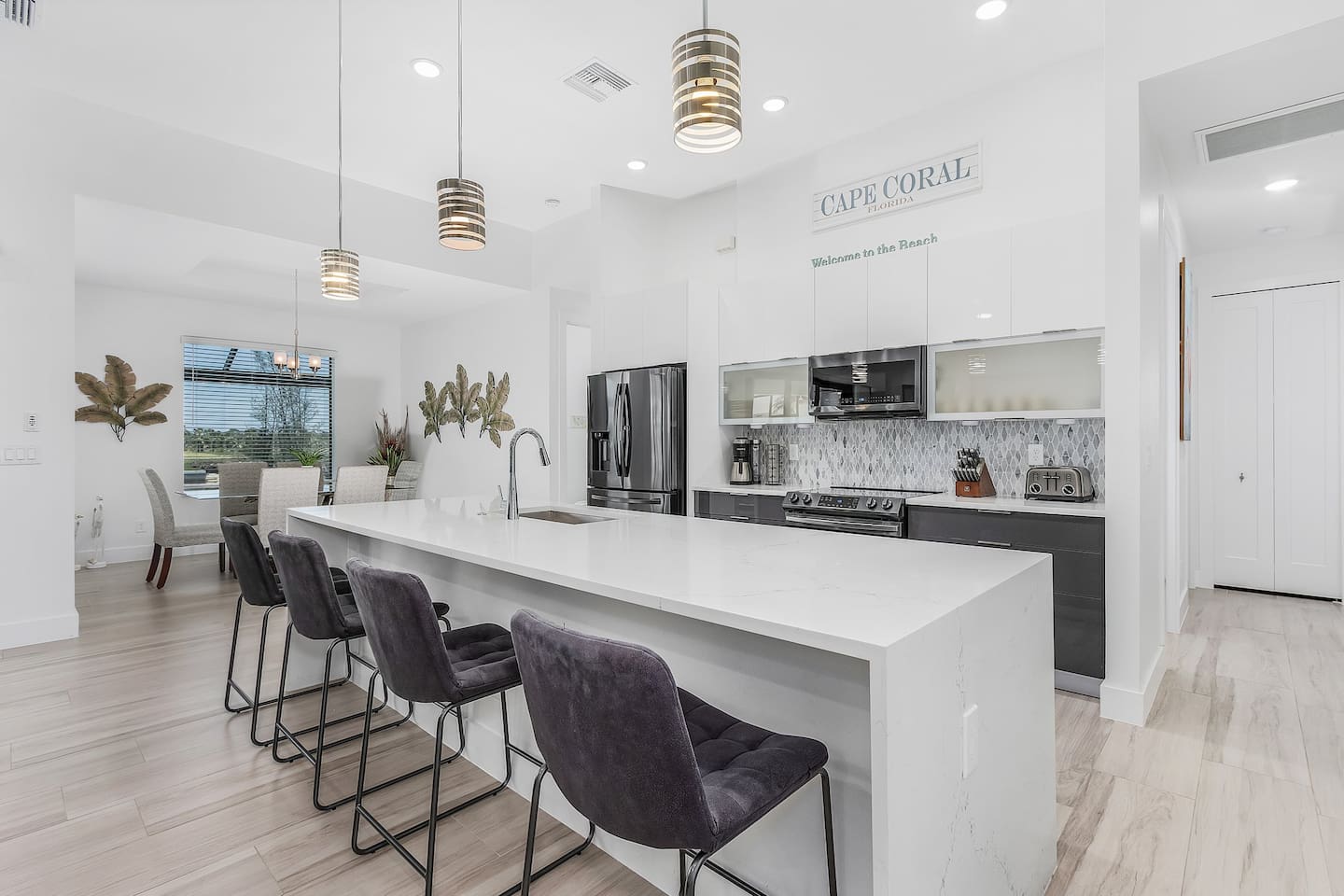 Indulge in a culinary adventure in the spacious kitchen, featuring modern appliances, a large island with seating for four, and ample room to create your favorite dishes.