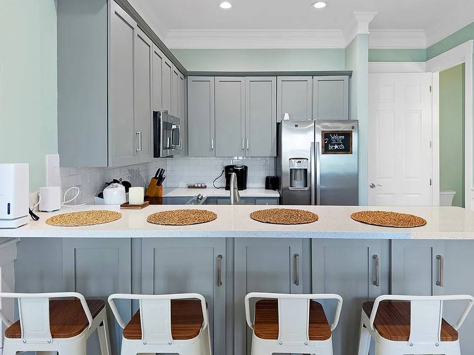 Island with room for seating or serving dinner.