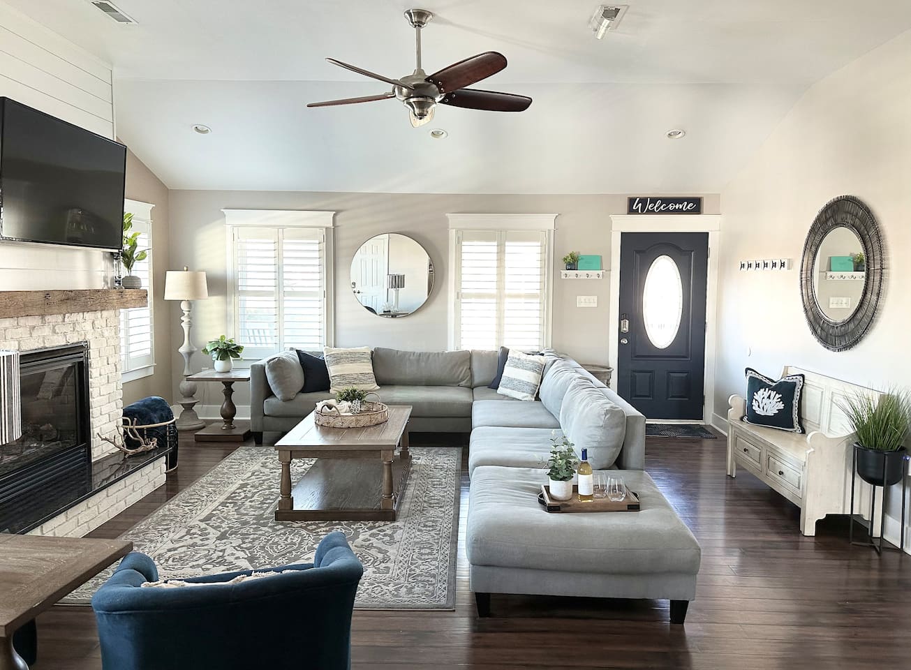 Step into our welcoming, sun-drenched living room where beachy charm meets modern comfort. With its vaulted ceilings, cozy fireplace, and sprawling sectional, it is the perfect spot for your family to gather and recharge.