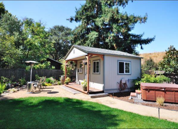 Cozy backyard setup w/ garden views & a relaxing hot tub area