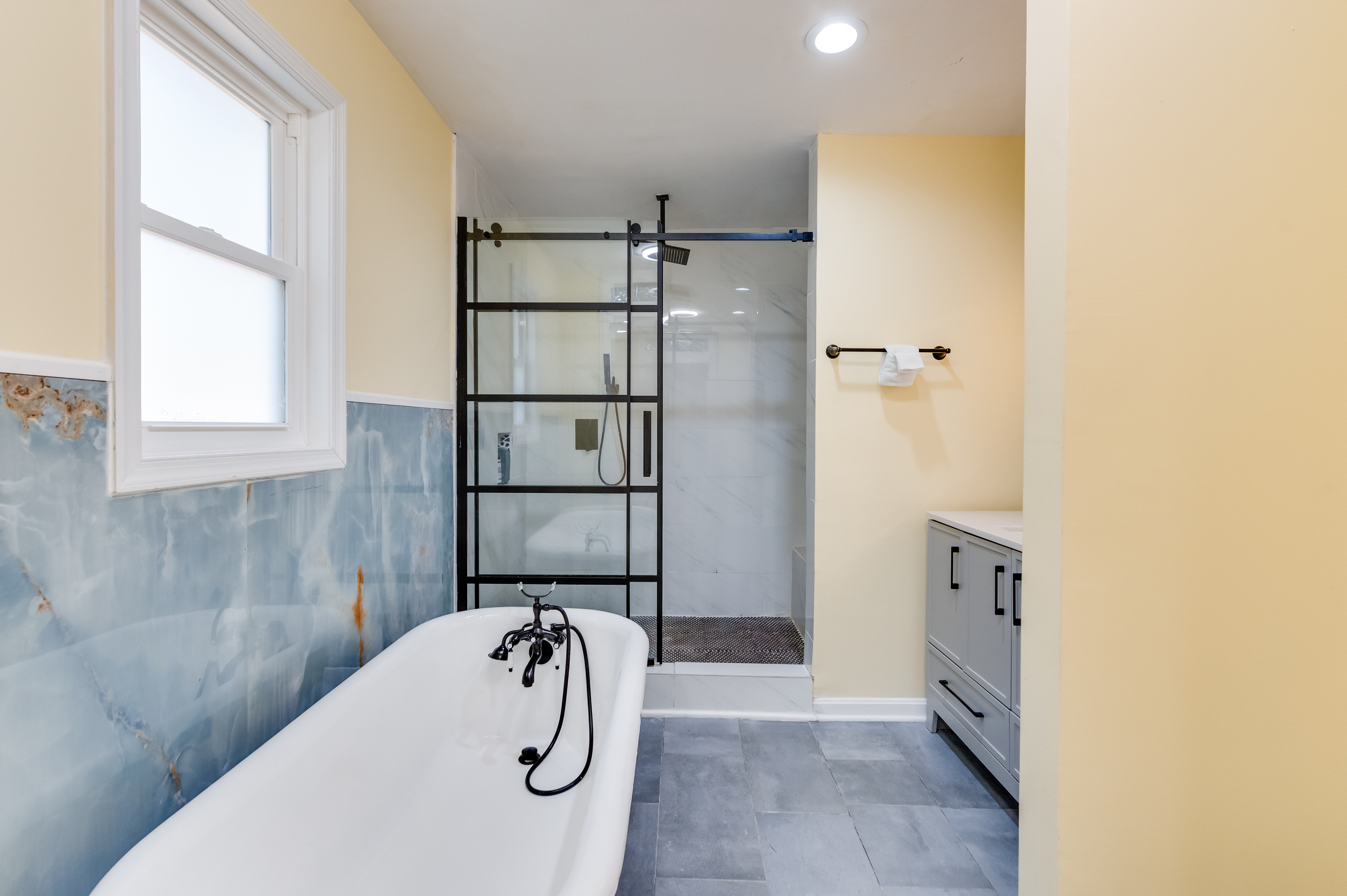 Upstairs Ensuite Full Bathroom 2: Relax in a stunning tub surrounded by vibrant decor and modern finishes!