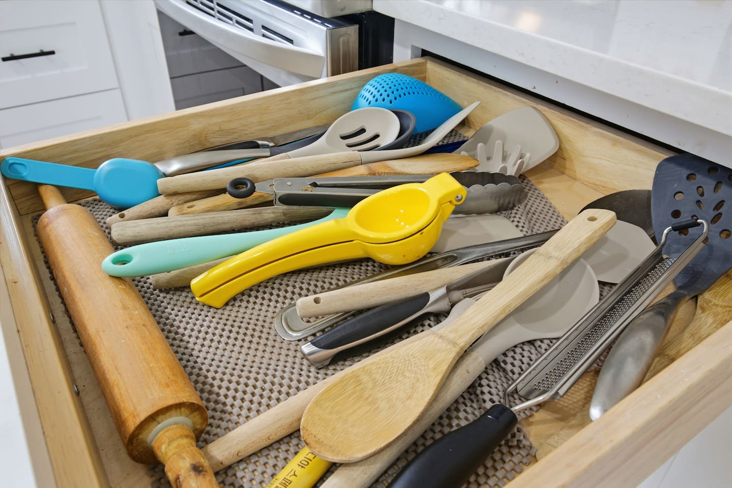 Organized utensil drawer with cooking tools, baking sheet access, and everything needed for home-style meals.