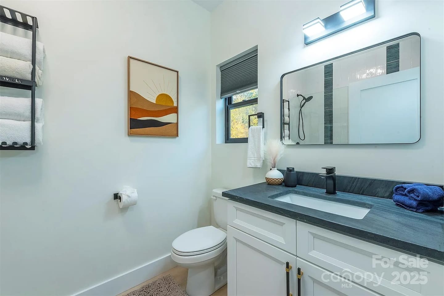 A stunning freestanding black soaking tub, elegant crystal chandelier, and modern matte black hardware. A serene, designer retreat perfect for ultimate relaxation and pampering.