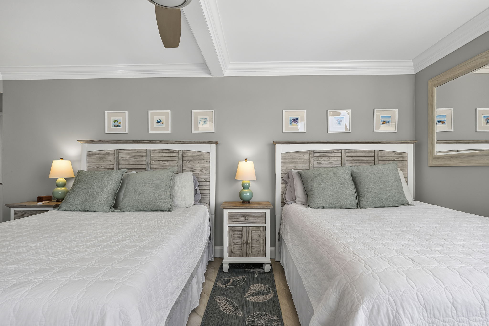 Guest bedroom with two full size beds and balcony access