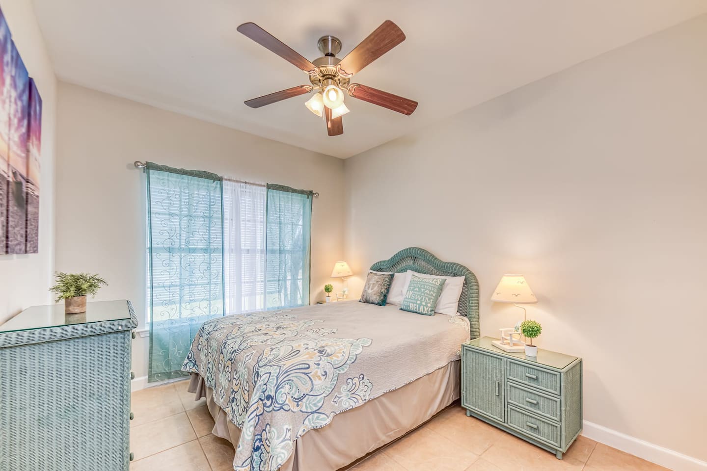 Bedroom Retreat: Bright room with beachy decor, tranquil views, and soft lighting for relaxation.