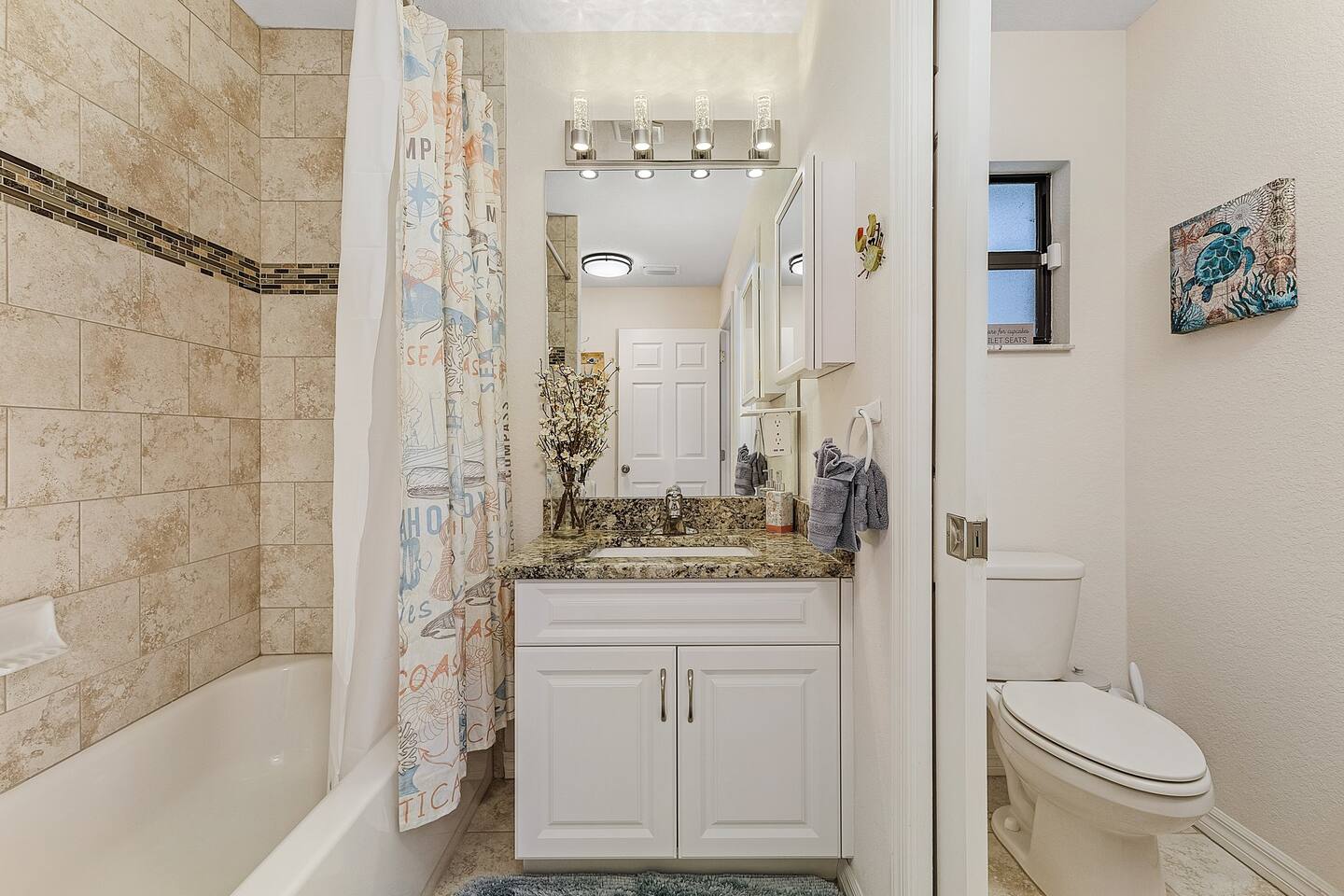 Guest bathroom featuring a shower and tub combo!