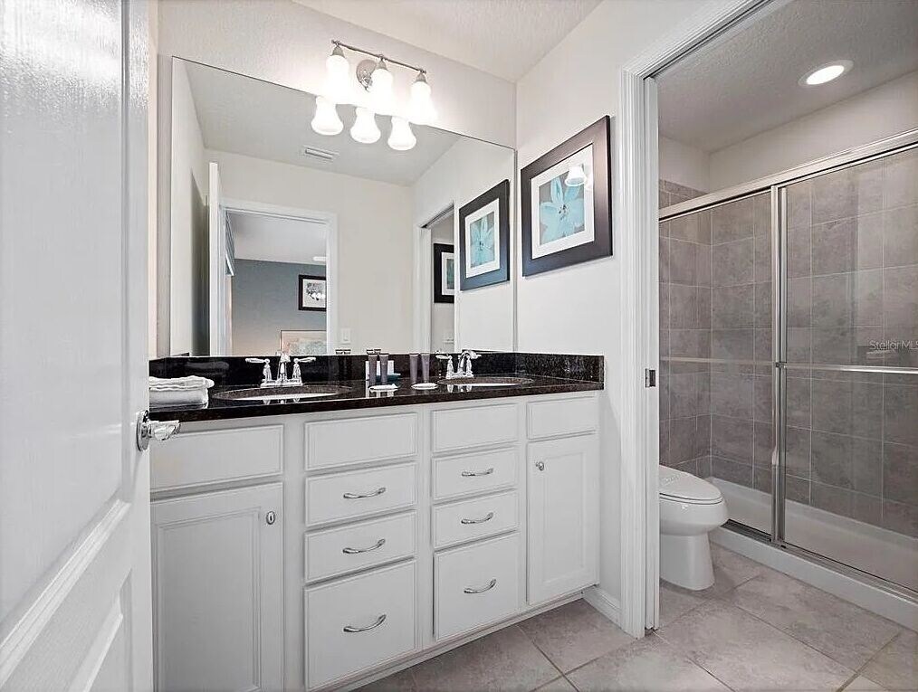 King BR ensuite bath with double sinks and separate stall for toilet and shower