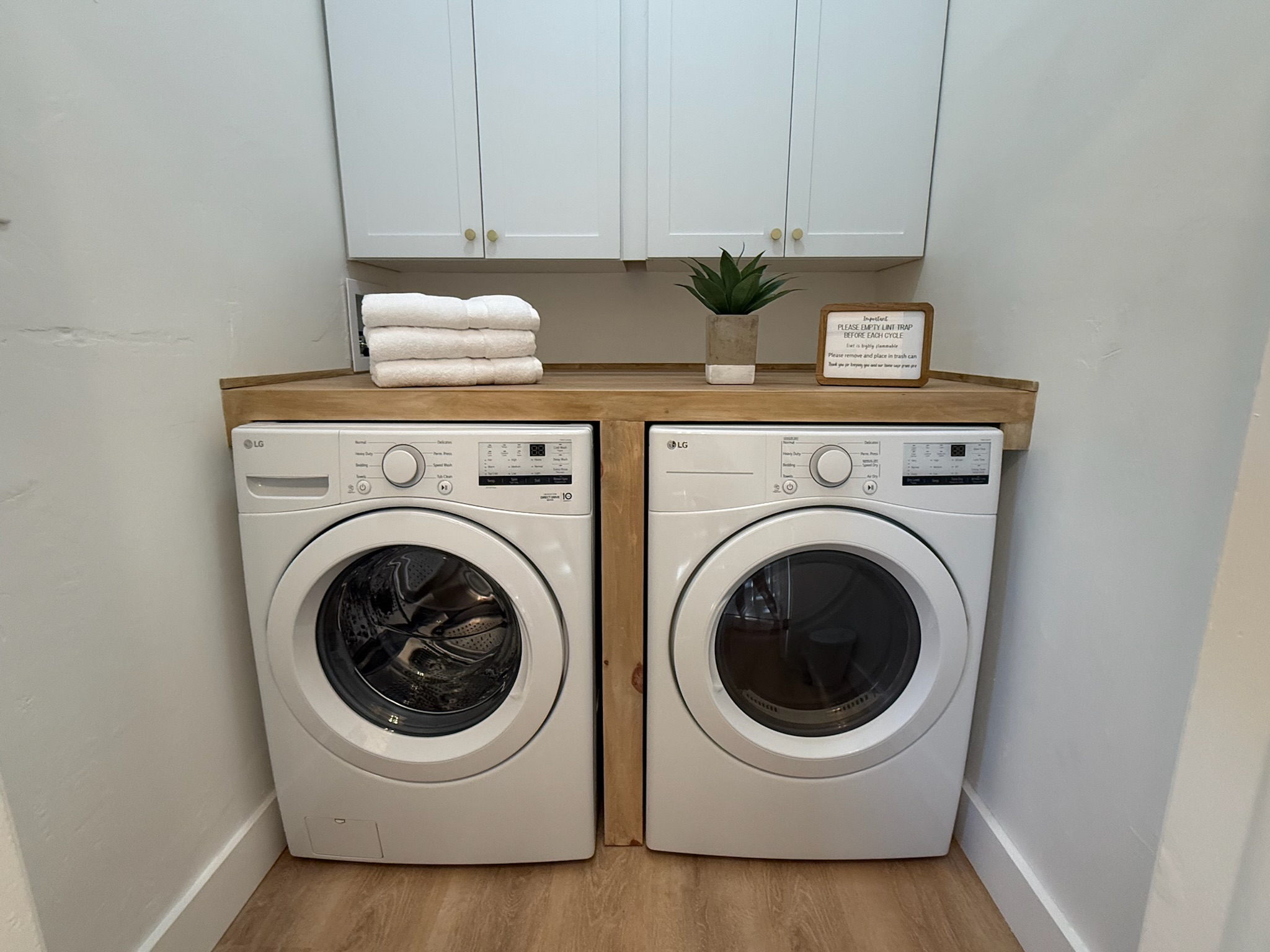 Laundry room featuring a full size washer and dryer and an extra large folding station