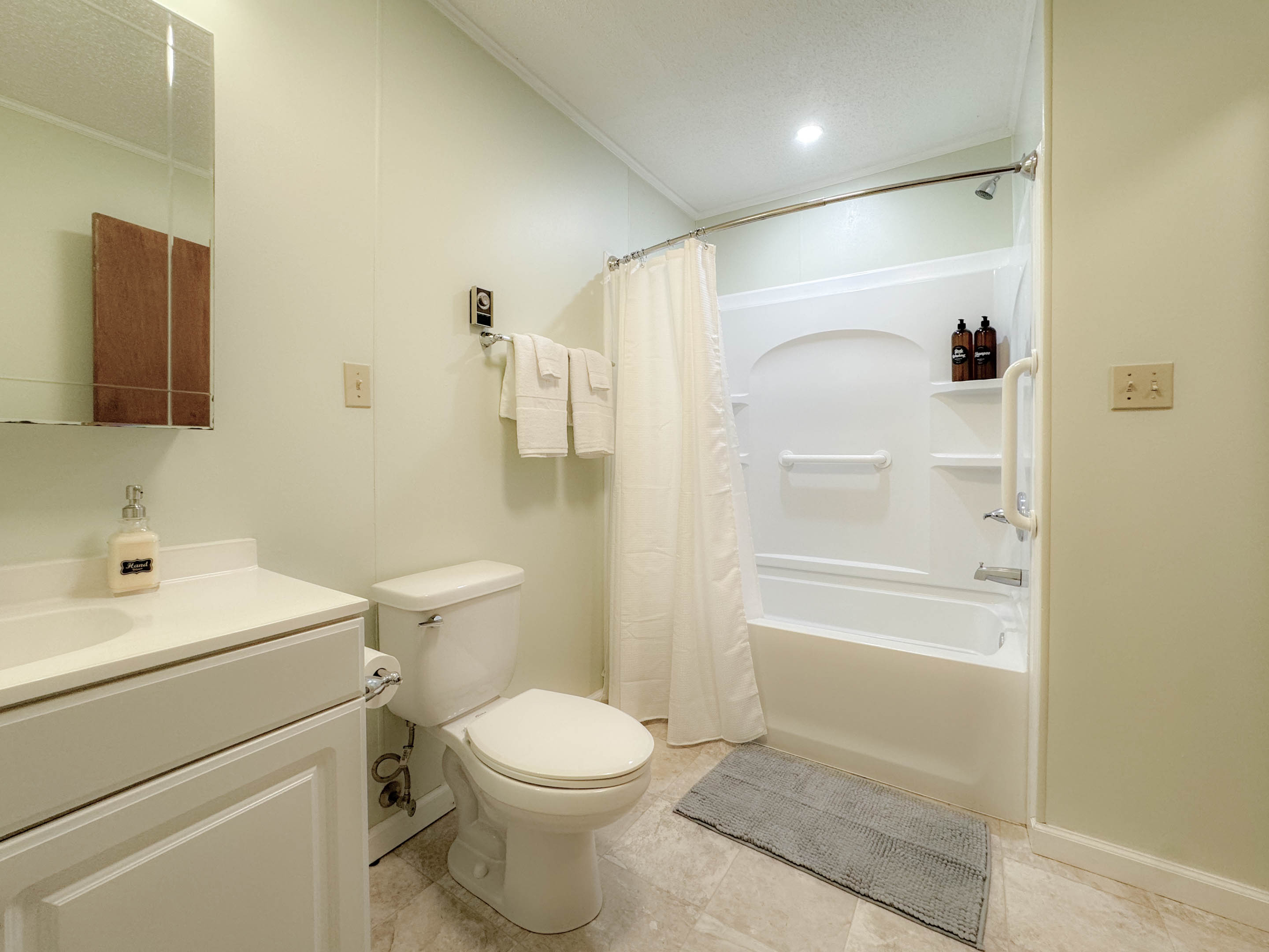 The guest bathroom is a nice size full bathroom complete with a tub/shower combination, toilet, and vanity. The bathroom is centrally located in the hallways between the two guest bedrooms.