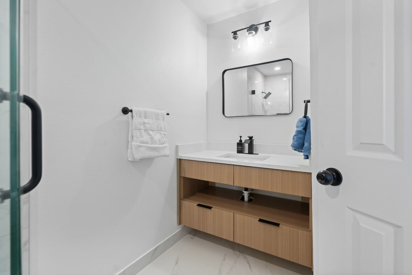 Second bathroom with spacious vanity storage and Ginger Lily Farms bath products stocked for your stay.