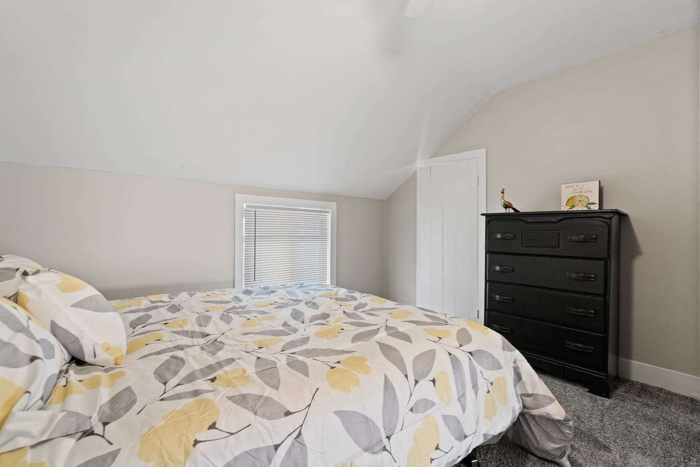 Cozy bedroom featuring a set of spacious drawers, offering ample storage for your belongings while keeping the room organized and clutter-free.