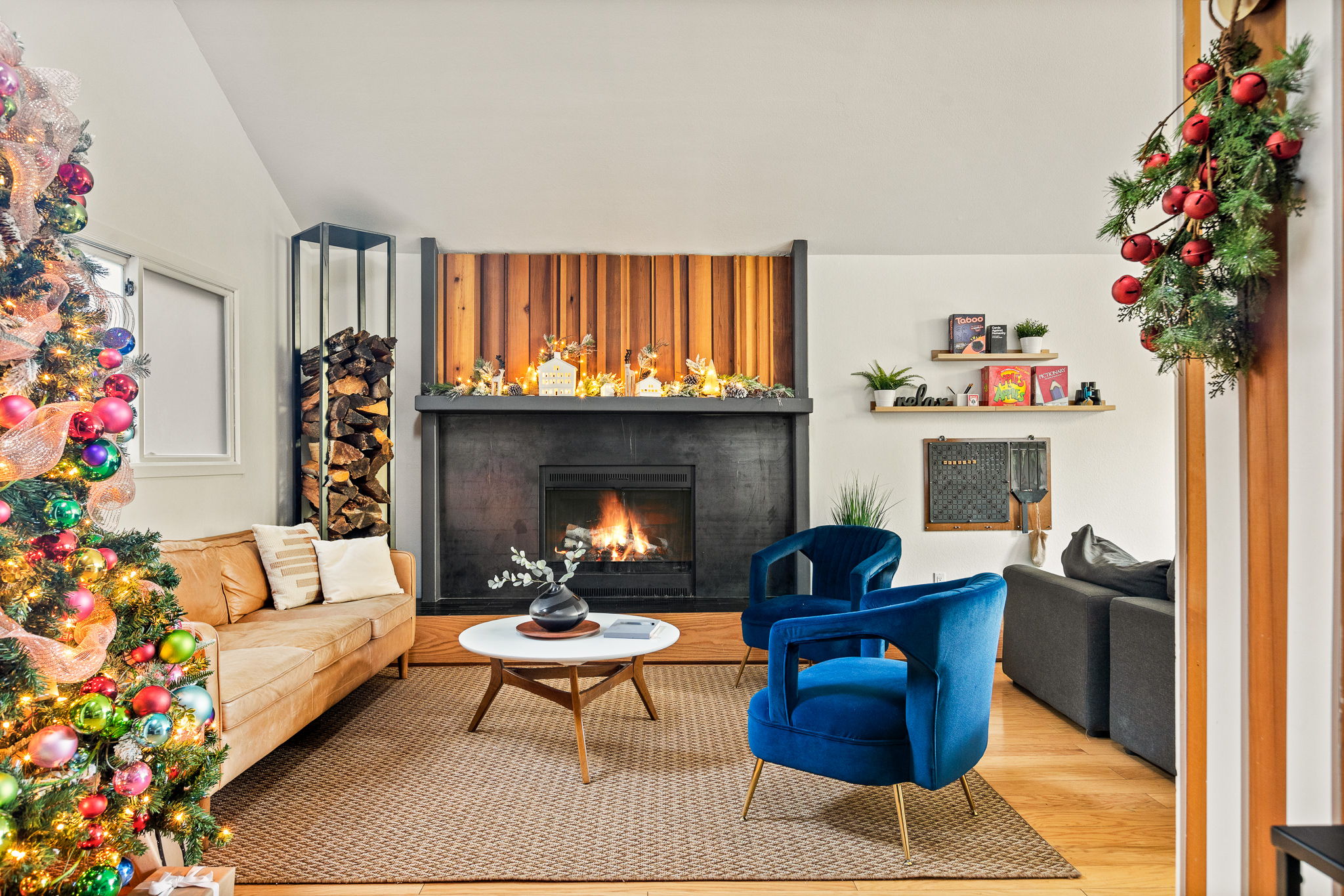 Cozy mountain cabin fireplace with warm holiday decor, glowing fire, and modern wood accents—perfect for a relaxing winter getaway in Lake Arrowhead.