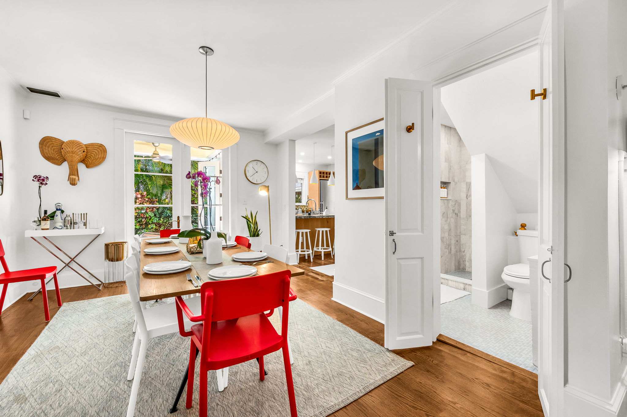 Tucked discreetly off the dining room, this hidden brand-new full bathroom features modern champagne gold fixtures, an LED lit vanity mirror and floating vanity, and a step-in luxury shower —proof that even the smallest spaces can shine.