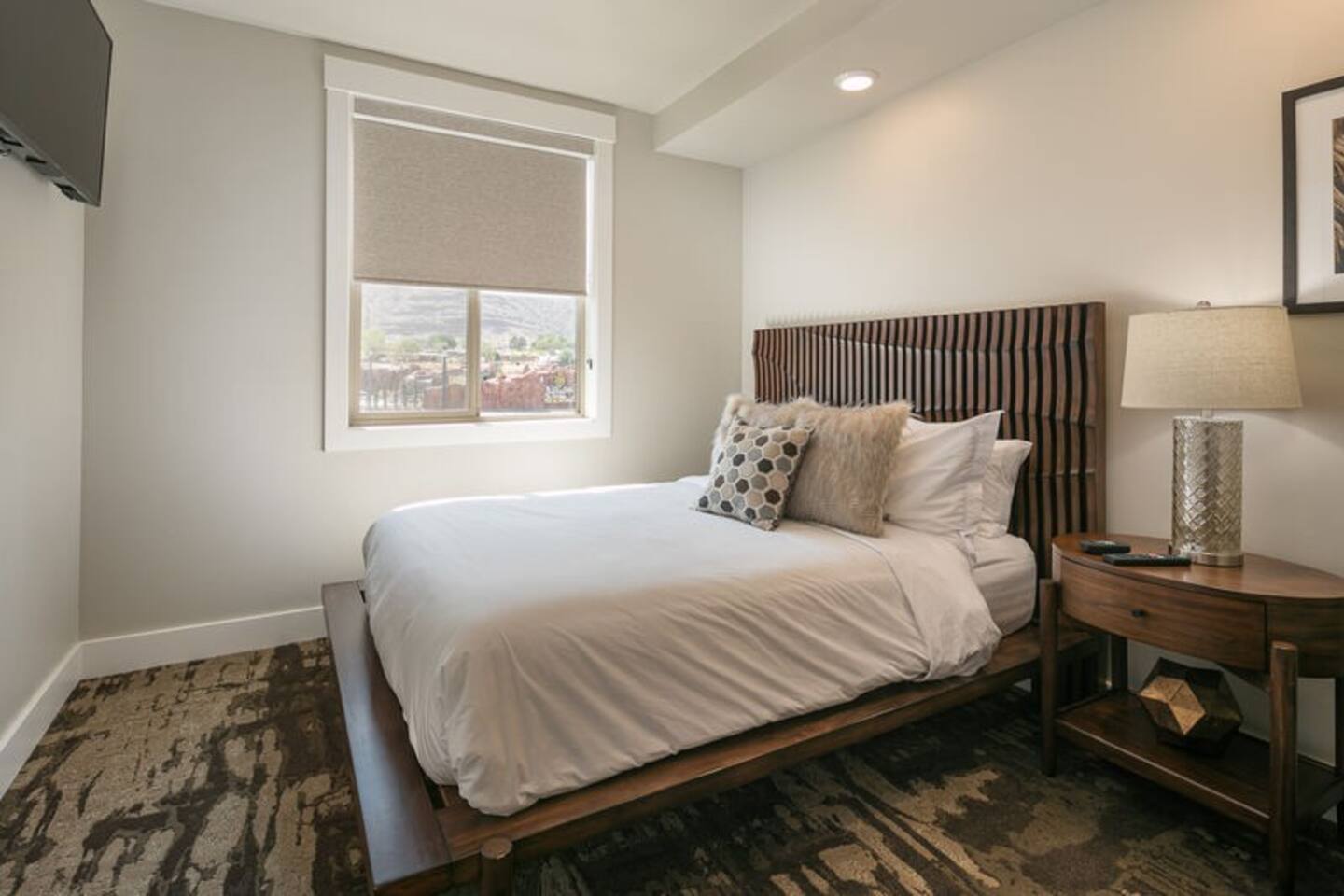 The inviting second bedroom provides lovely views, a large TV, and a high end queen bed for your comfort.