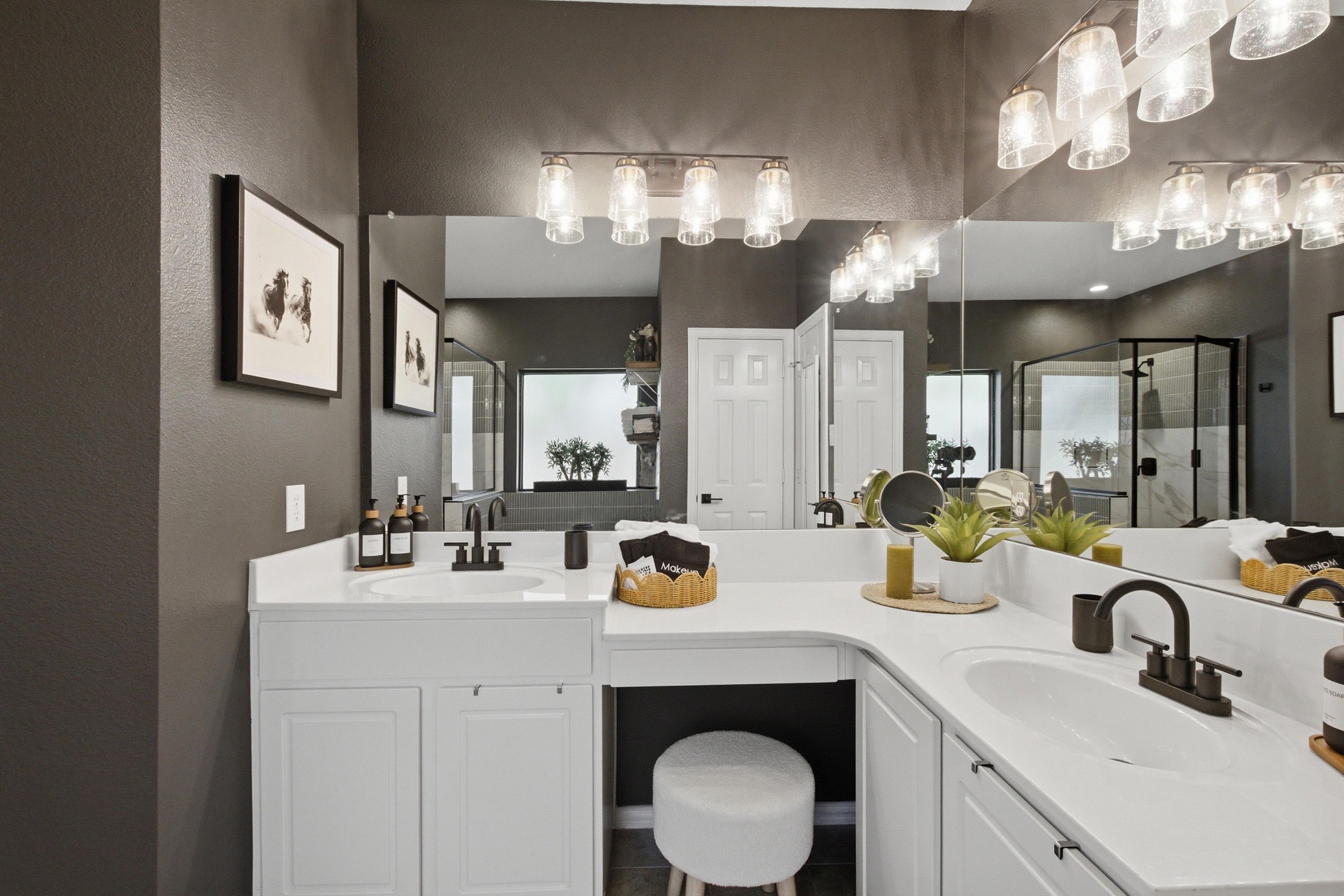Master Bathroom double Vanity with dual mirrors, ample counter space, and warm pendant lighting. Stocked with essentials by Ginger Lily Farms.

